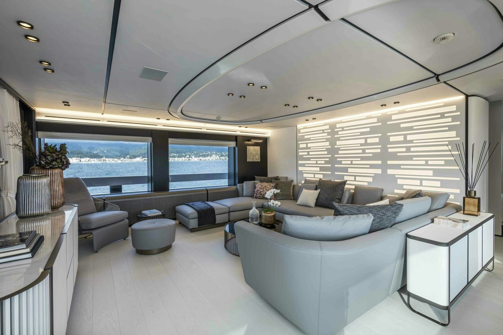 a living room with a large window aboard X130 TRIPLEX Yacht for Sale