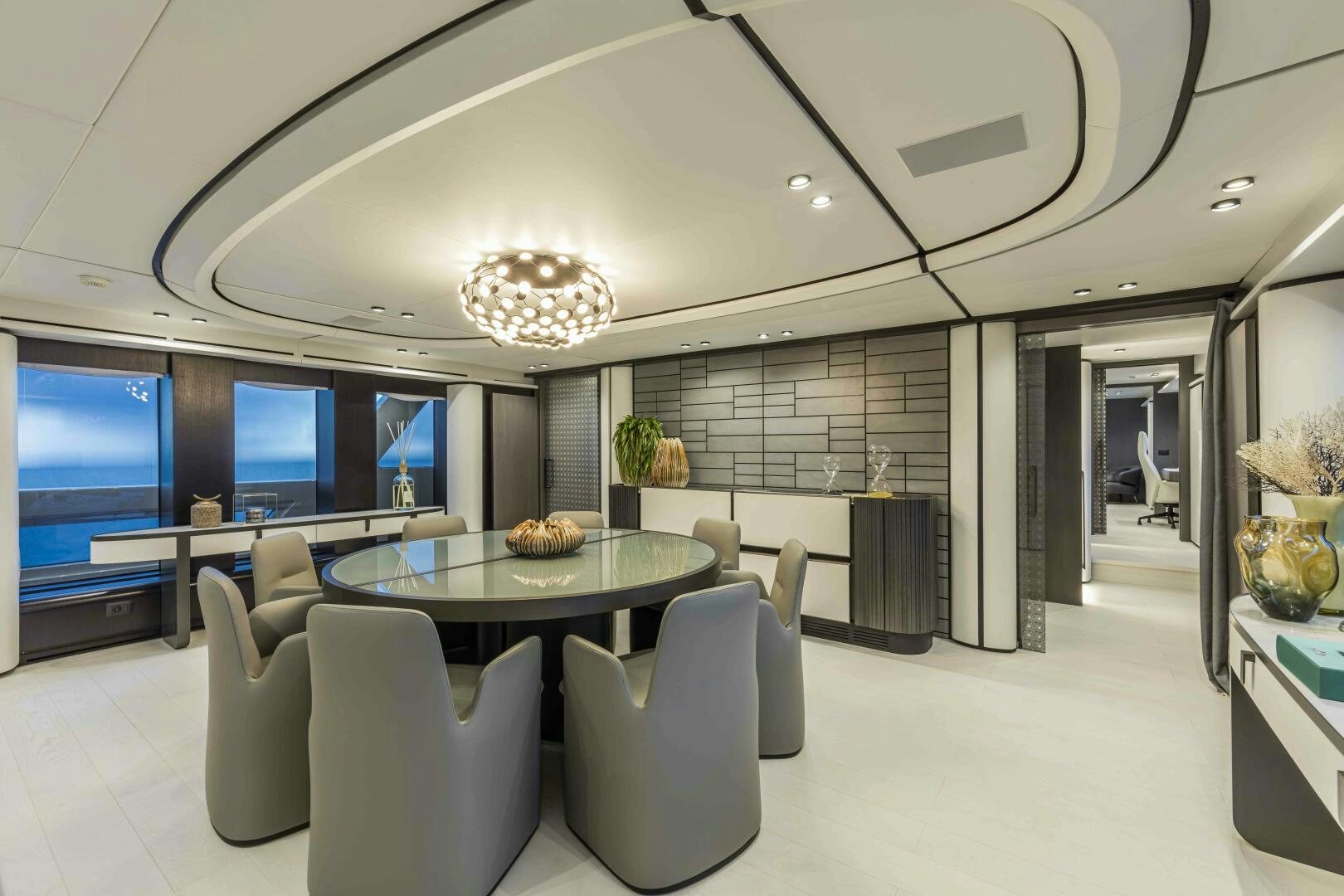 a large room with a table and chairs aboard X130 TRIPLEX Yacht for Sale