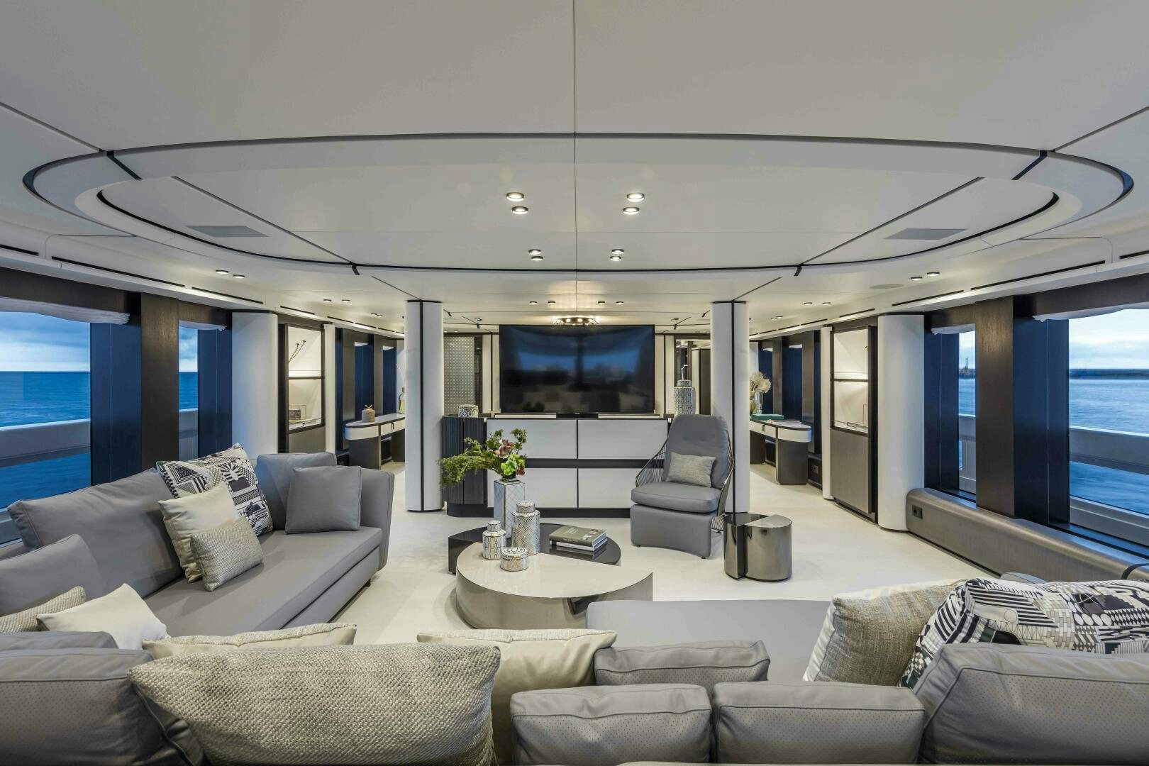 a living room with a large window aboard X130 TRIPLEX Yacht for Sale