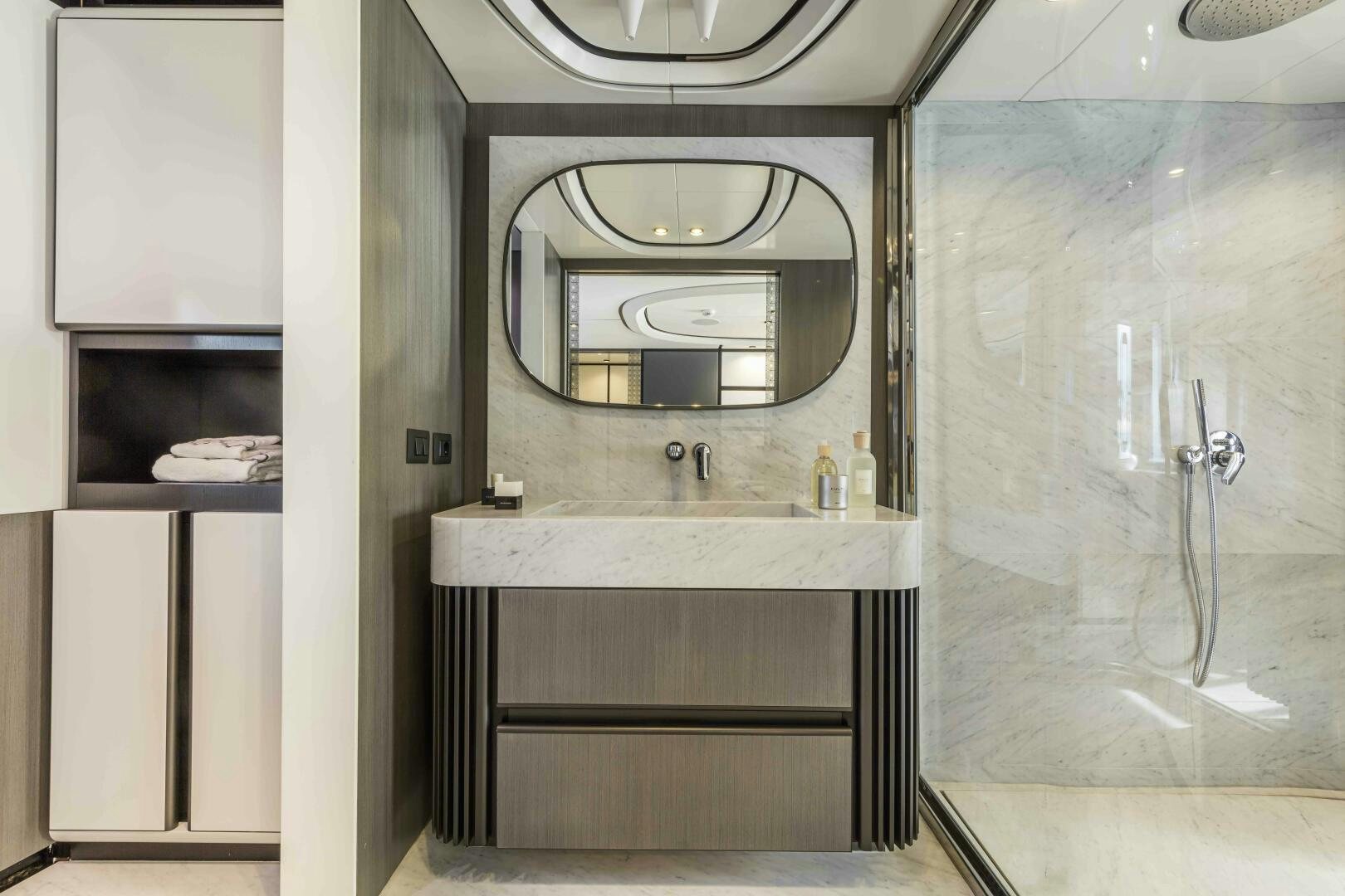 a bathroom with a sink and a mirror aboard X130 TRIPLEX Yacht for Sale