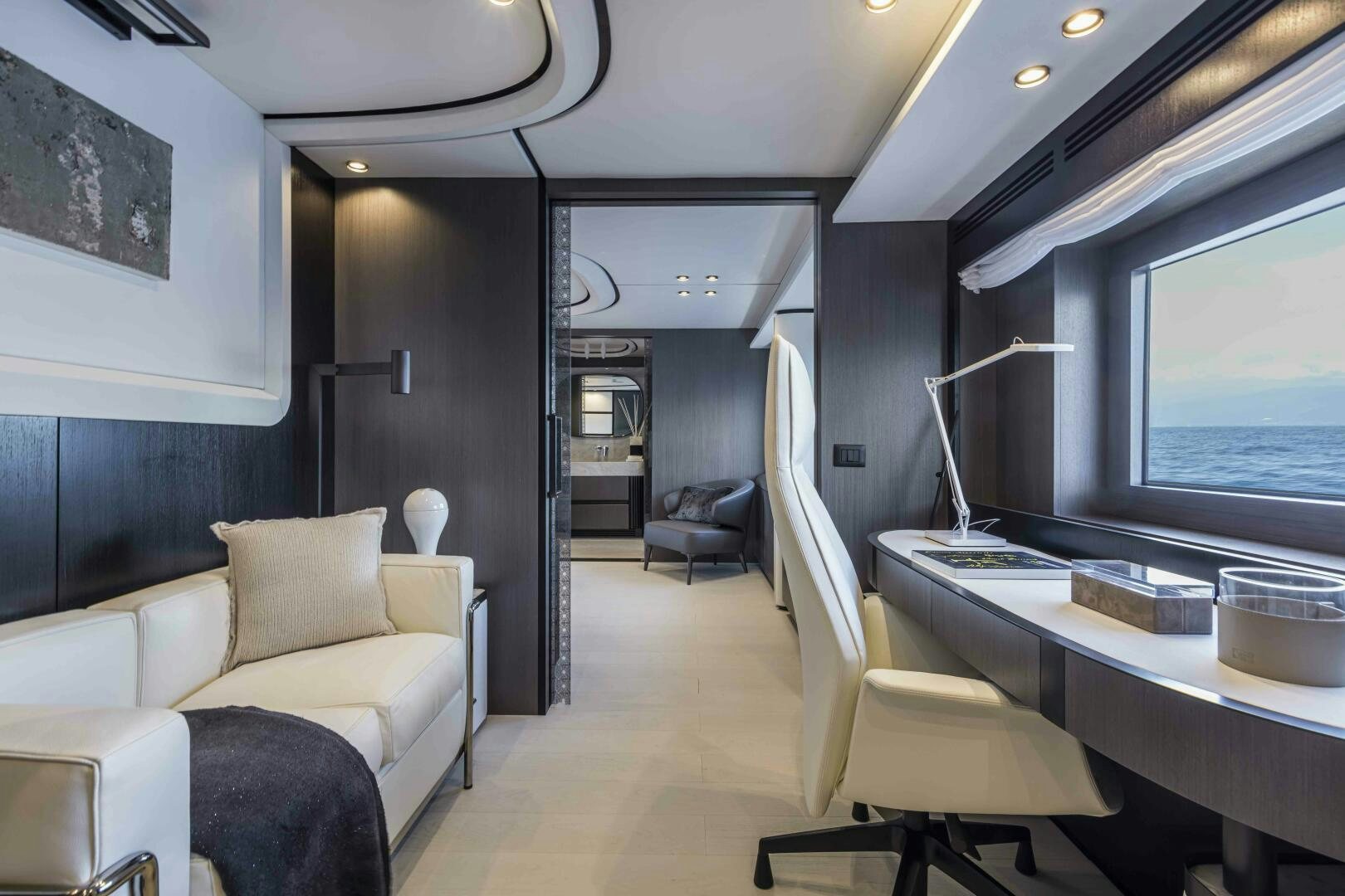 a room with a couch and a table and a television aboard X130 TRIPLEX Yacht for Sale