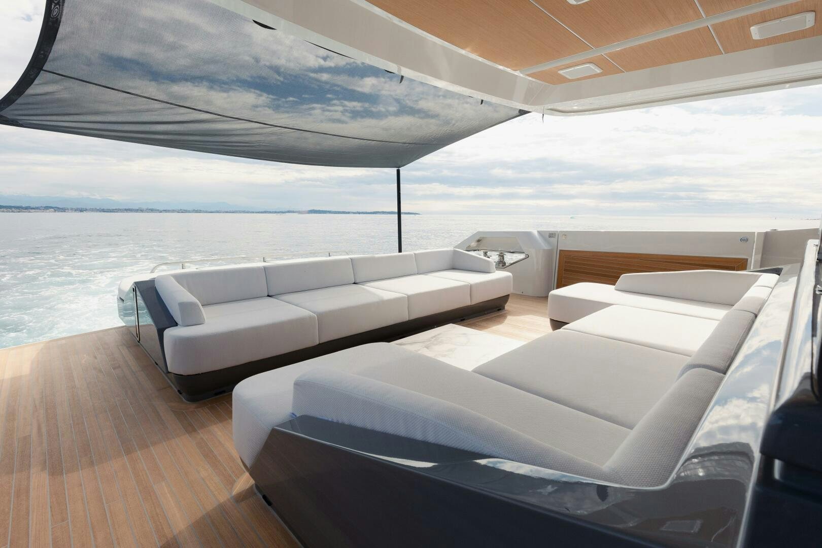 a room with a bed and a couch aboard X99 FAST Yacht for Sale