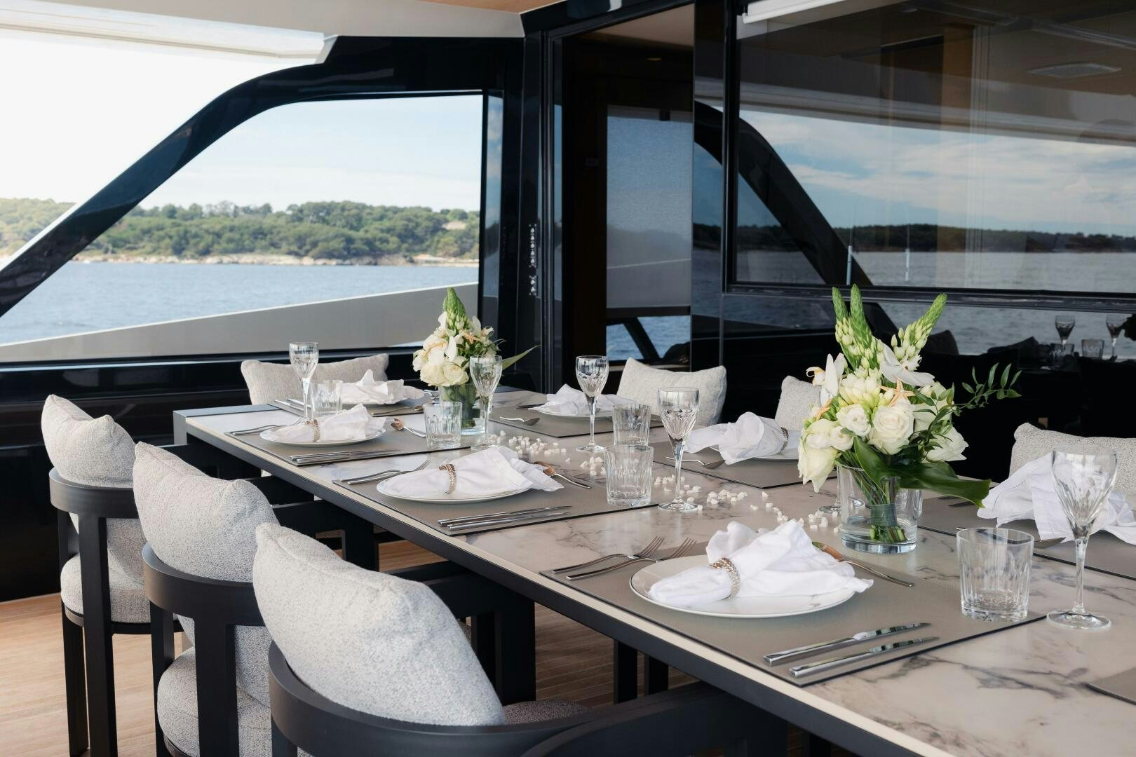 a table set with place settings aboard X99 FAST Yacht for Sale