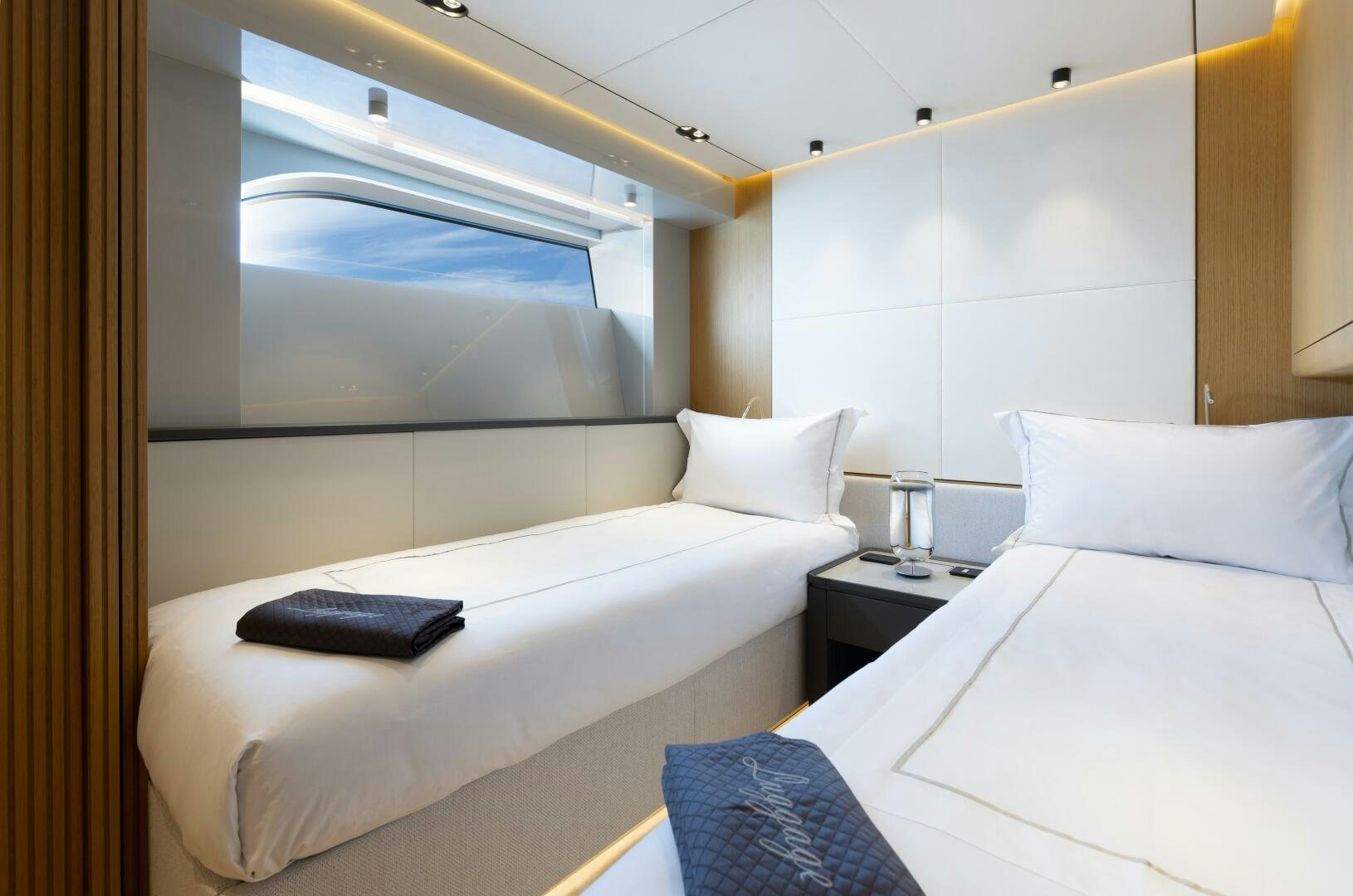 a room with two beds aboard X99 FAST Yacht for Sale