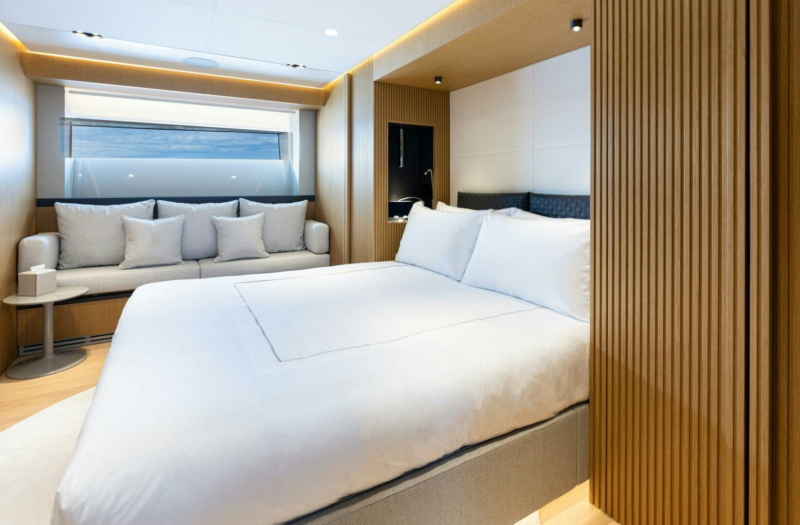 a bed with white sheets aboard X99 FAST Yacht for Sale