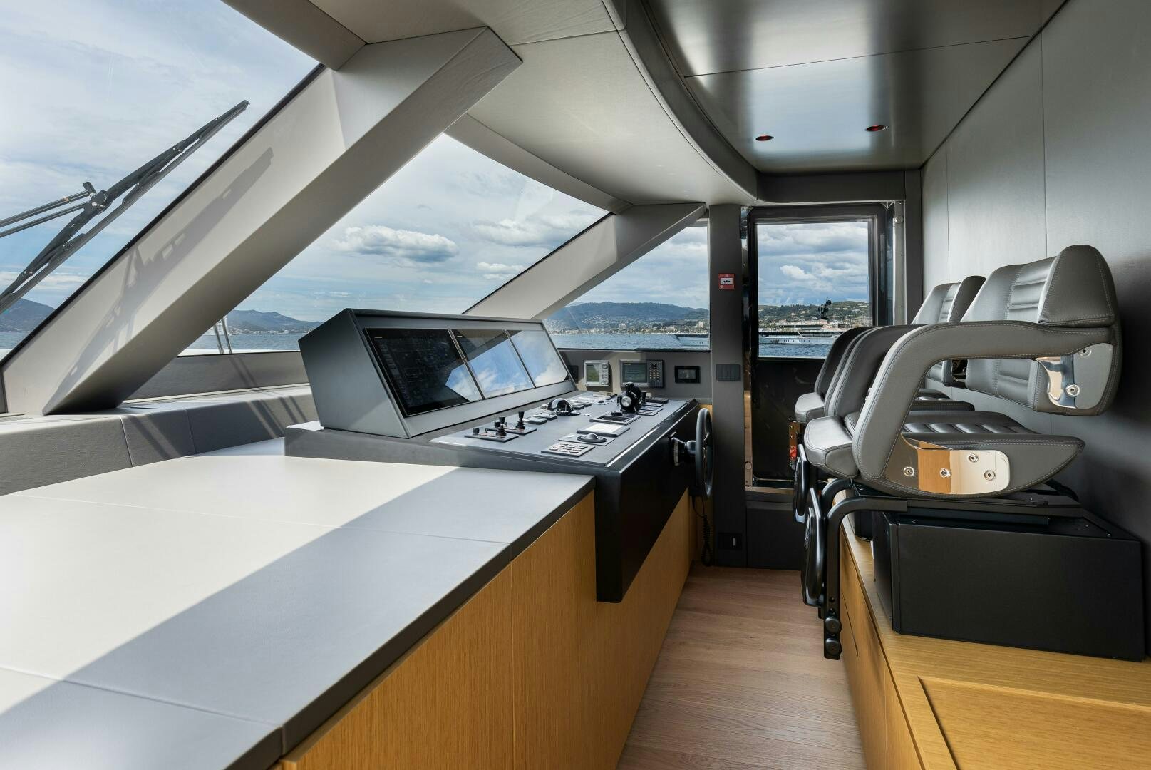 inside of a vehicle with a desk and a laptop on a table aboard X99 FAST Yacht for Sale