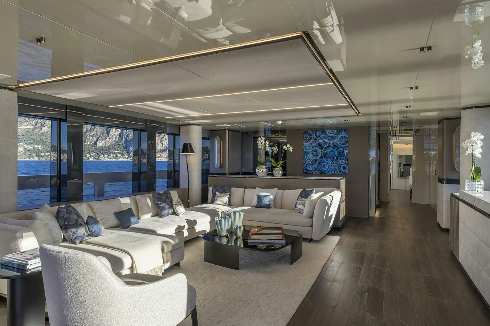 a living room with a large window aboard X96 TRIPLEX Yacht for Sale