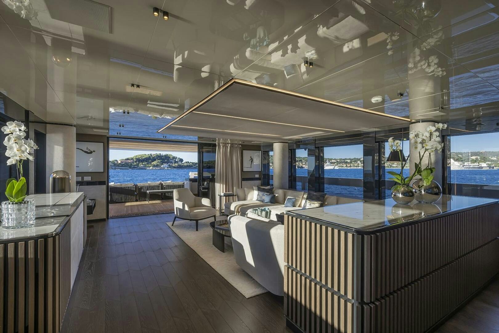 a modern looking living room with a large open window aboard X96 TRIPLEX Yacht for Sale