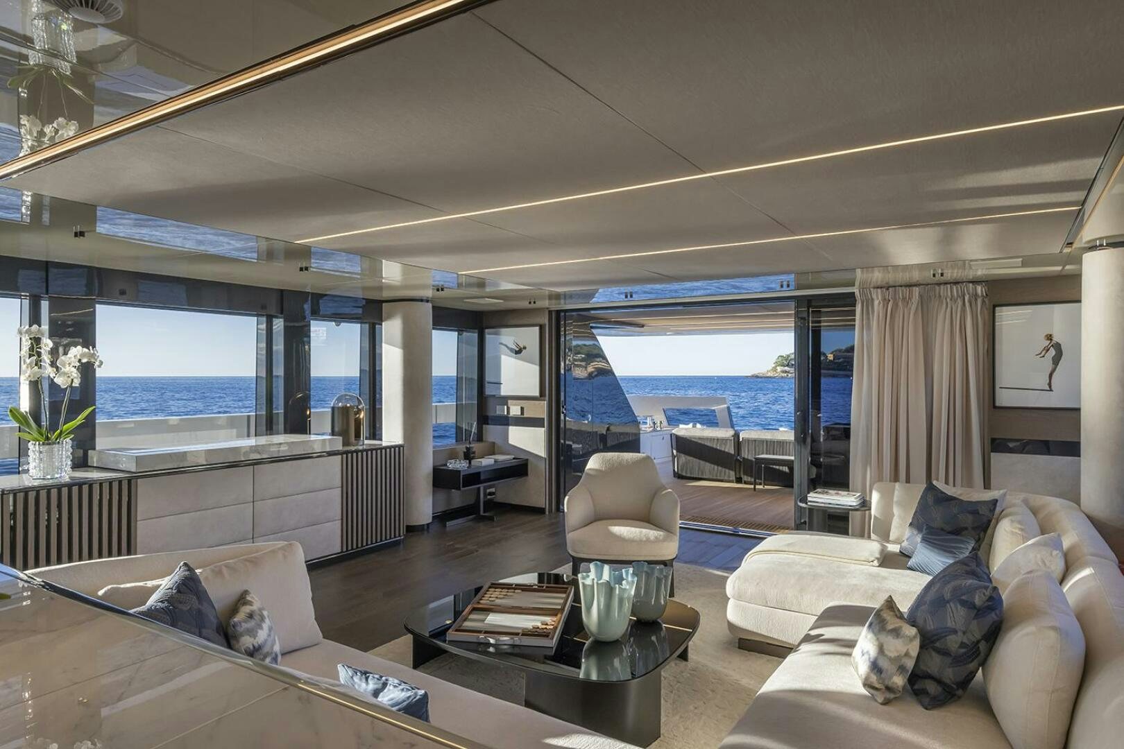 a living room with a large window aboard X96 TRIPLEX Yacht for Sale