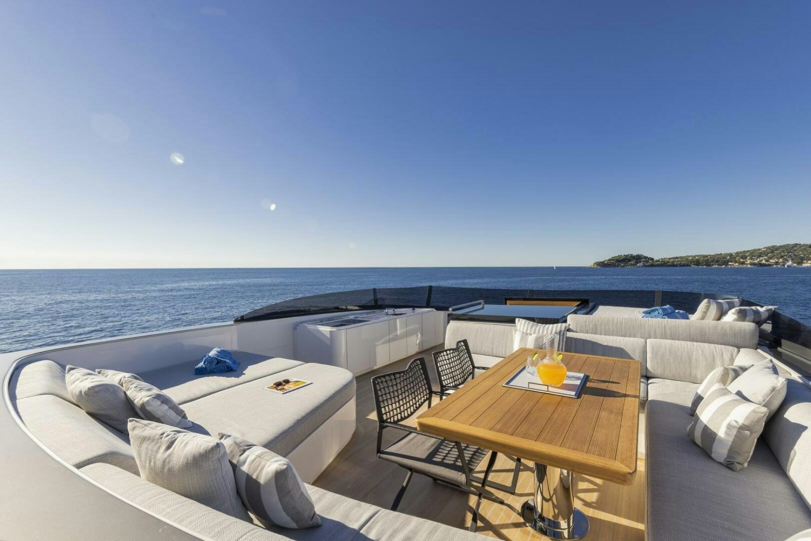 a room with a bed and a table and chairs on the beach aboard X96 TRIPLEX Yacht for Sale
