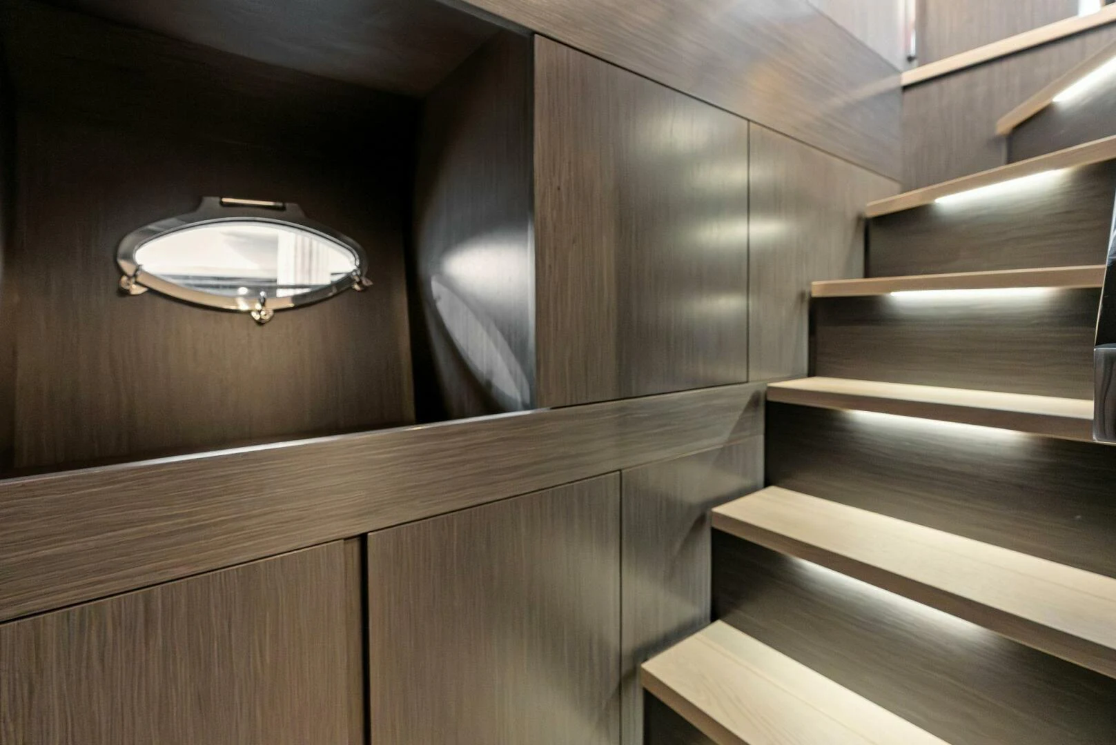 a wooden staircase with a light fixture aboard OUR TRADE Yacht for Sale