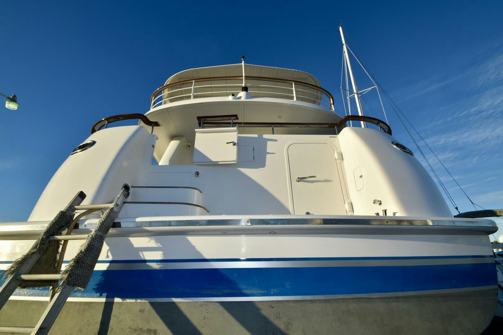 a white boat on a dock aboard BLUE SEAS Yacht for Sale