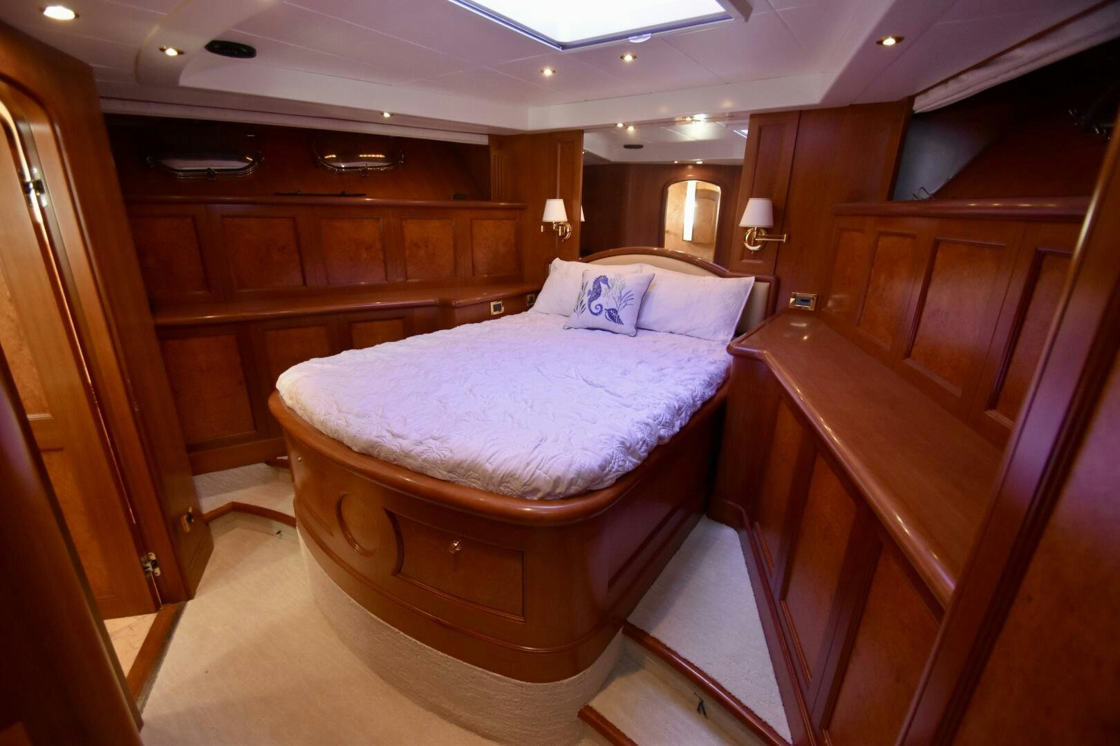 a bedroom with a bed and cabinets aboard BLUE SEAS Yacht for Sale