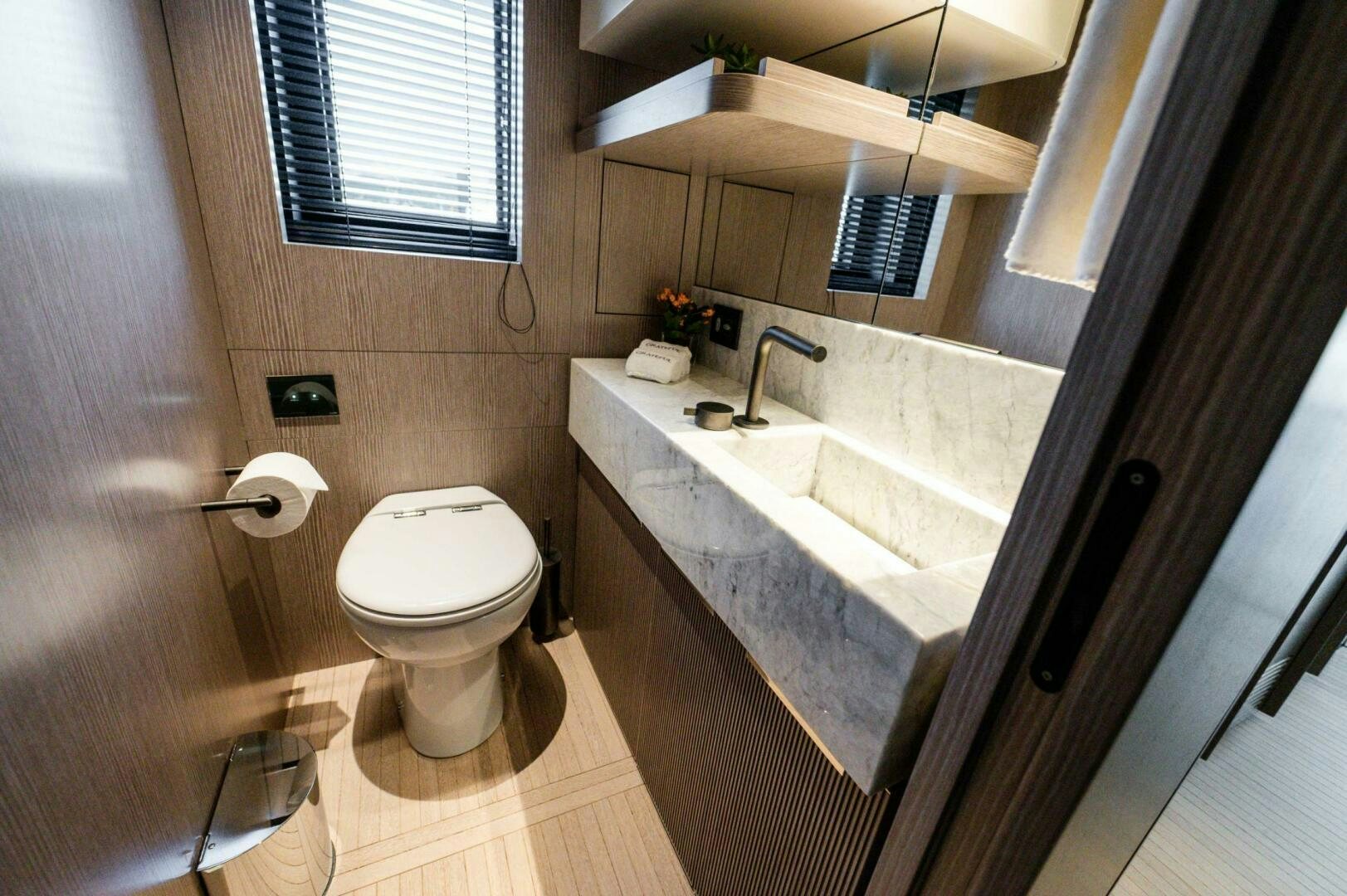 a bathroom with a toilet and sink aboard SEAESTA Yacht for Sale