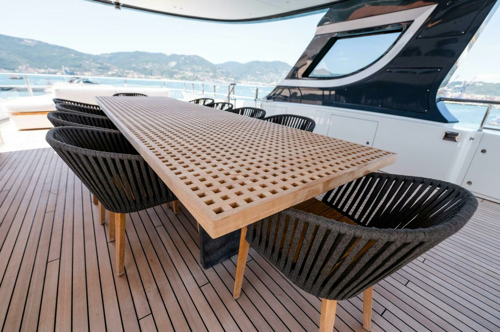 a deck with a table and chairs on it aboard SEAESTA Yacht for Sale