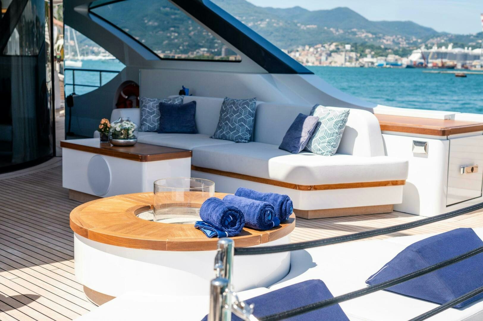 a table with a couch and a window overlooking a city aboard SEAESTA Yacht for Sale