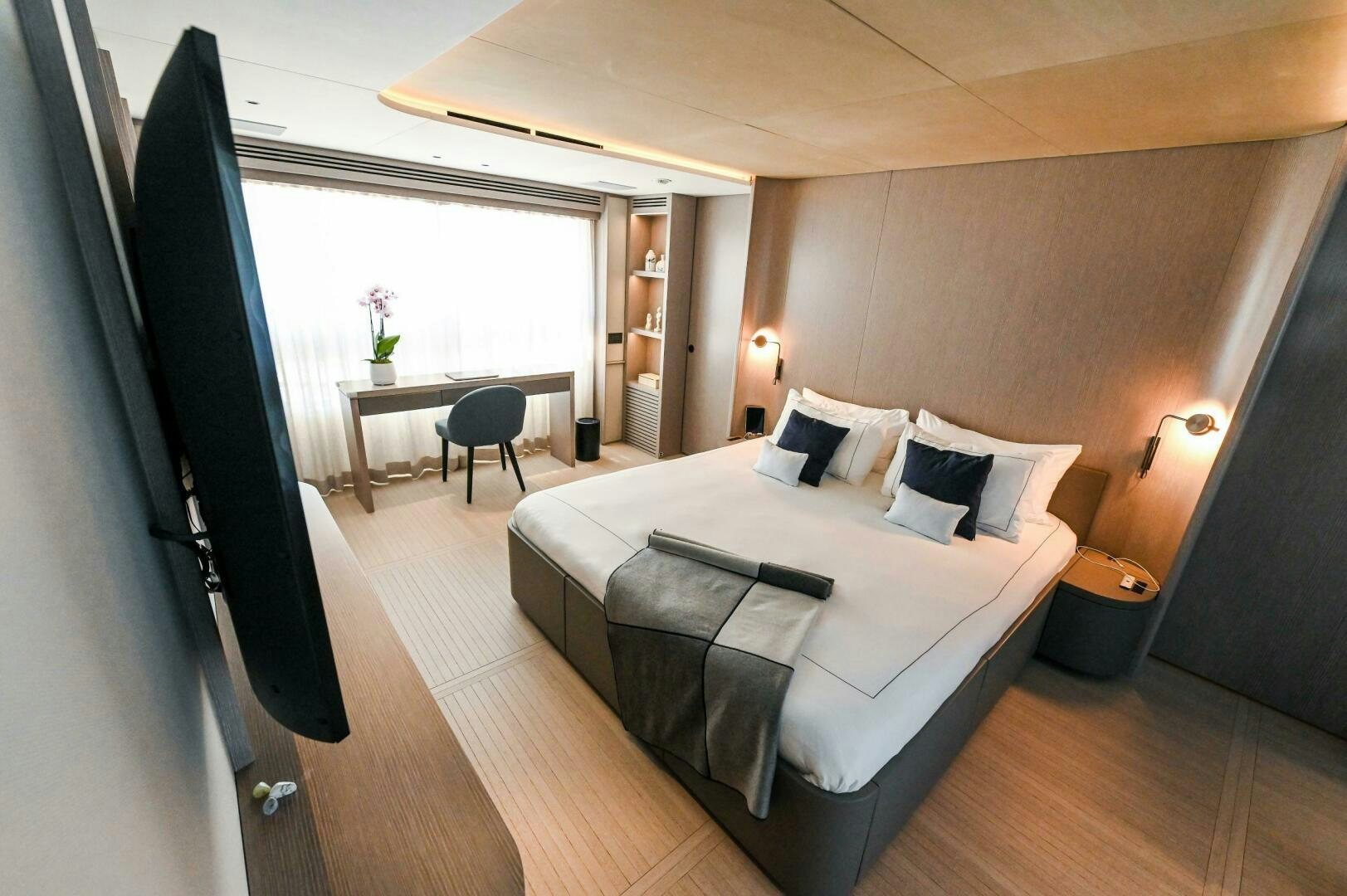 a bed with a white sheet on it aboard SEAESTA Yacht for Sale