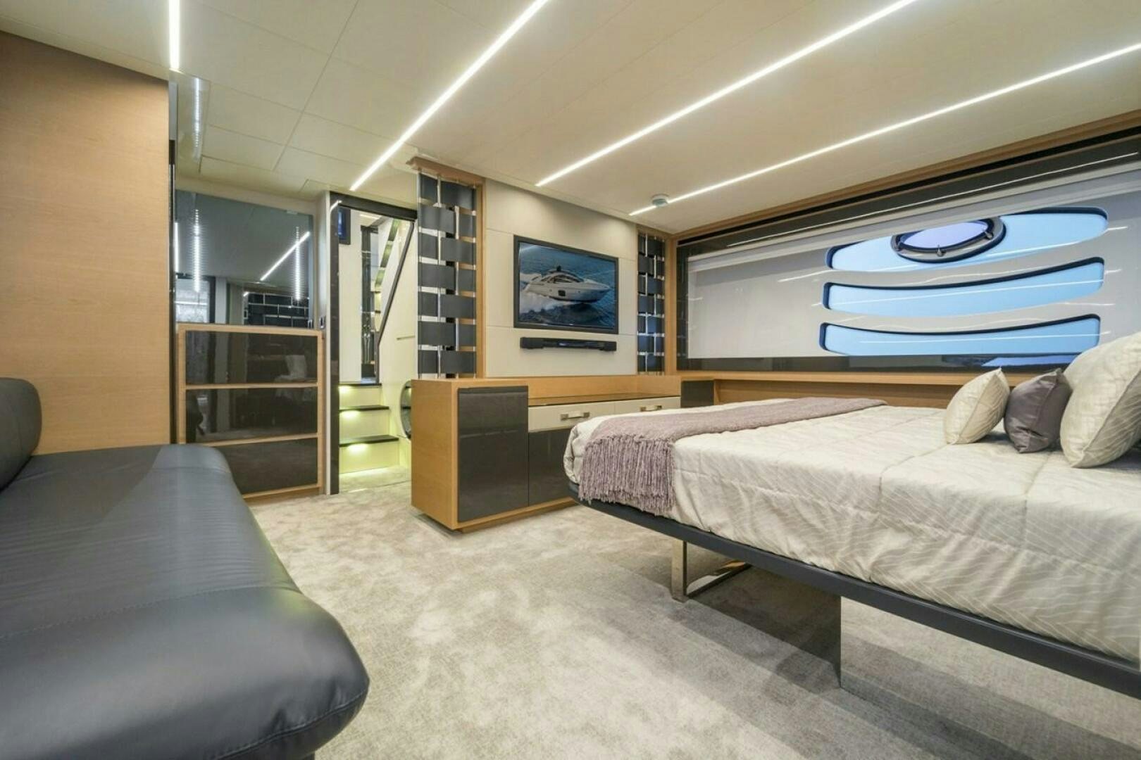 a bedroom with a bed and a couch aboard STAR Yacht for Sale