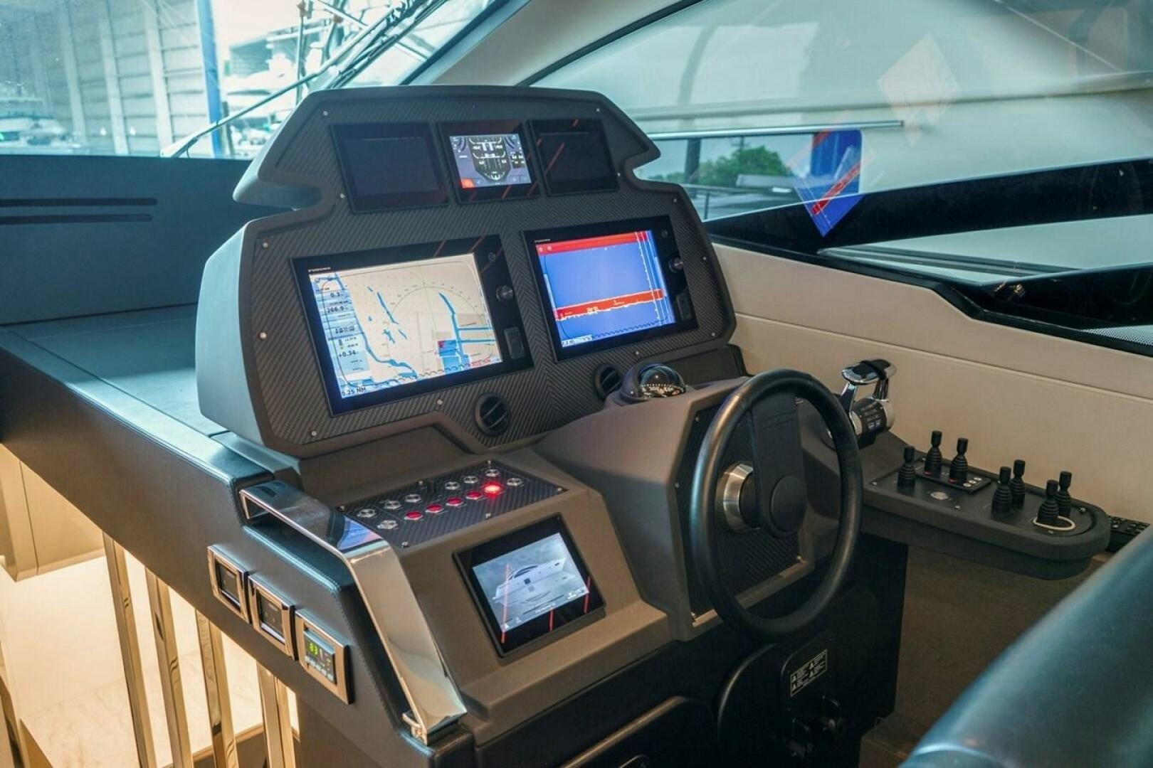 a car with a screen and a monitor on the dashboard aboard STAR Yacht for Sale