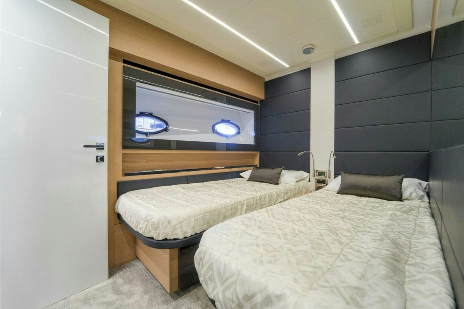 a room with a bed and a television aboard STAR Yacht for Sale