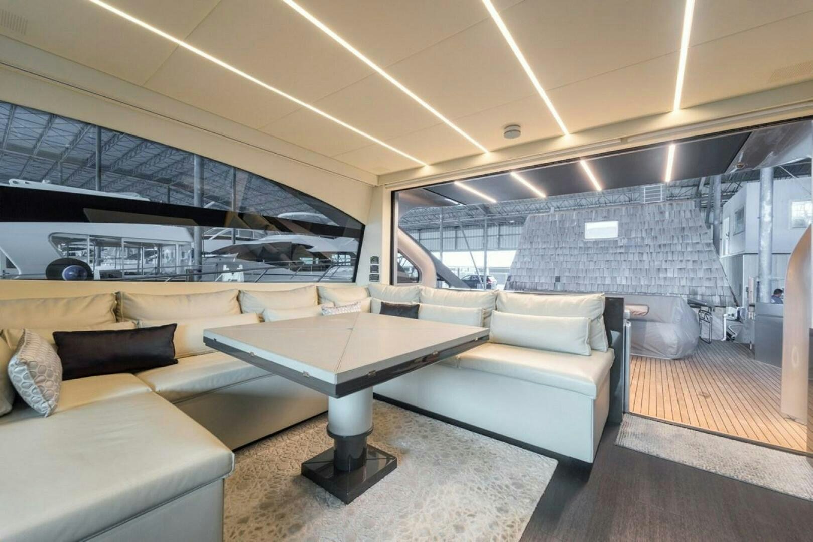 a room with a couch and a table aboard STAR Yacht for Sale