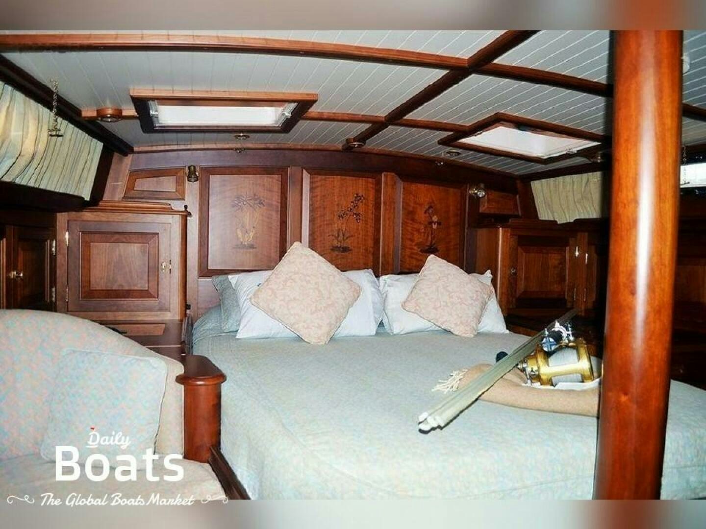 a bedroom with a bed and a wood wall aboard SEE ADLER Yacht for Sale