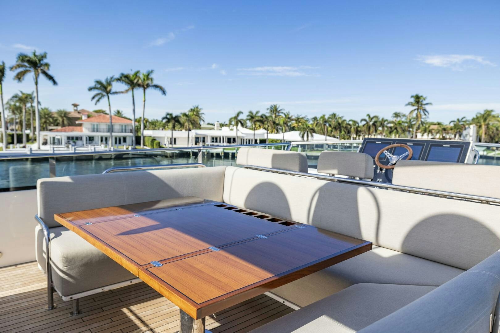 a pool with lounge chairs and a table on a sunny day aboard SEABISCUIT Yacht for Sale