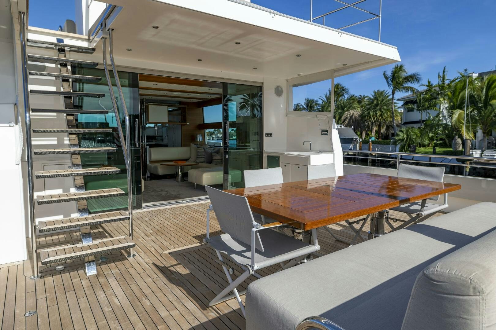 a deck with a table and chairs aboard SEABISCUIT Yacht for Sale