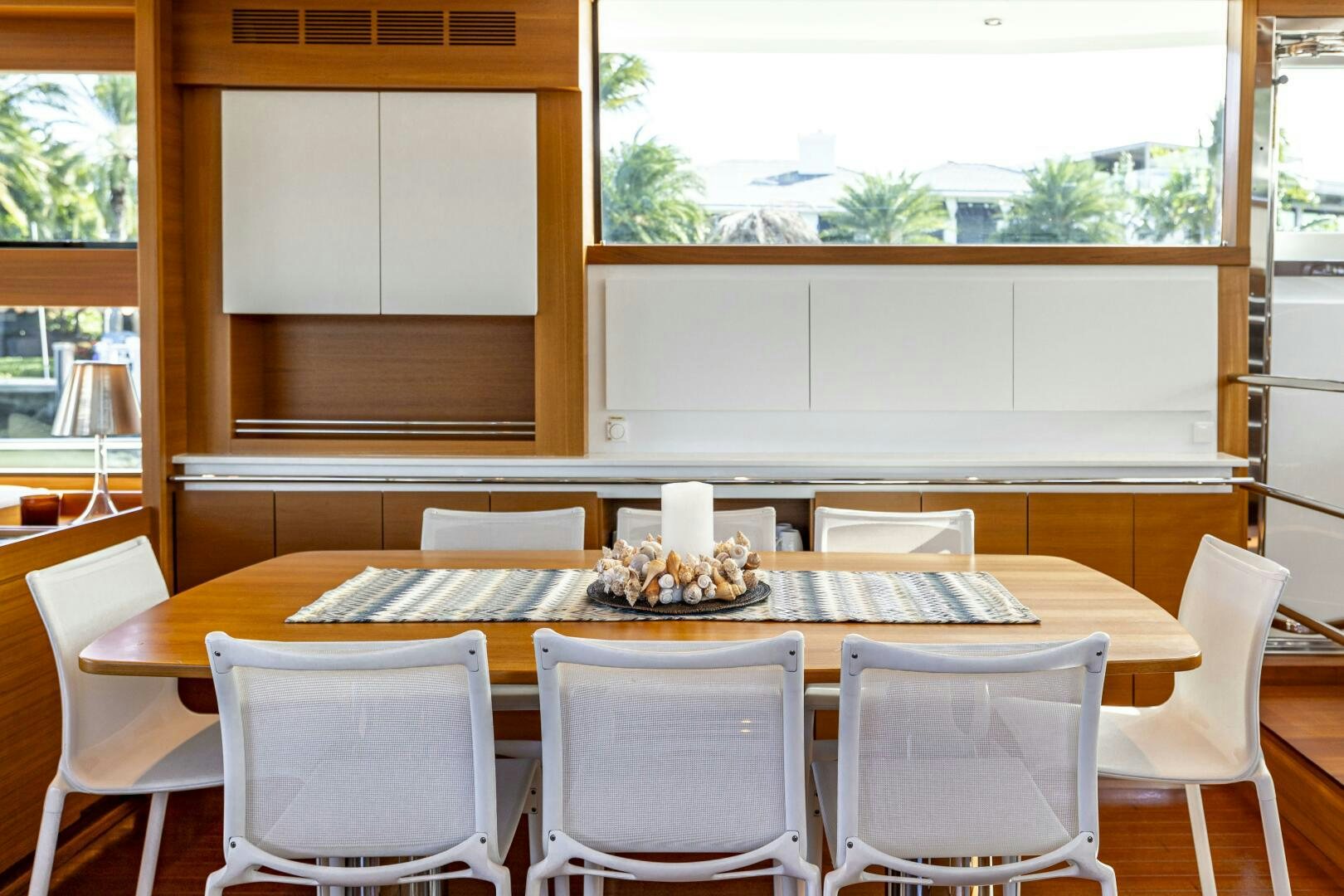 a dining table with chairs and a large screen aboard SEABISCUIT Yacht for Sale