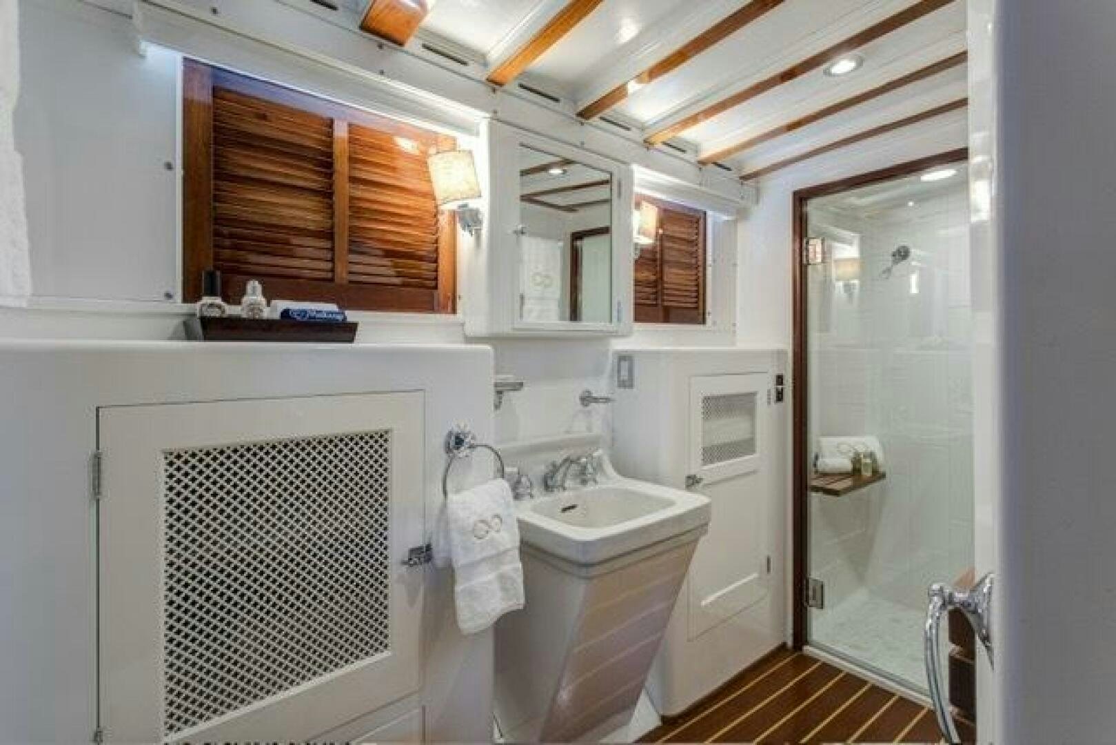 a bathroom with a sink and cabinets aboard TIMELESS Yacht for Sale