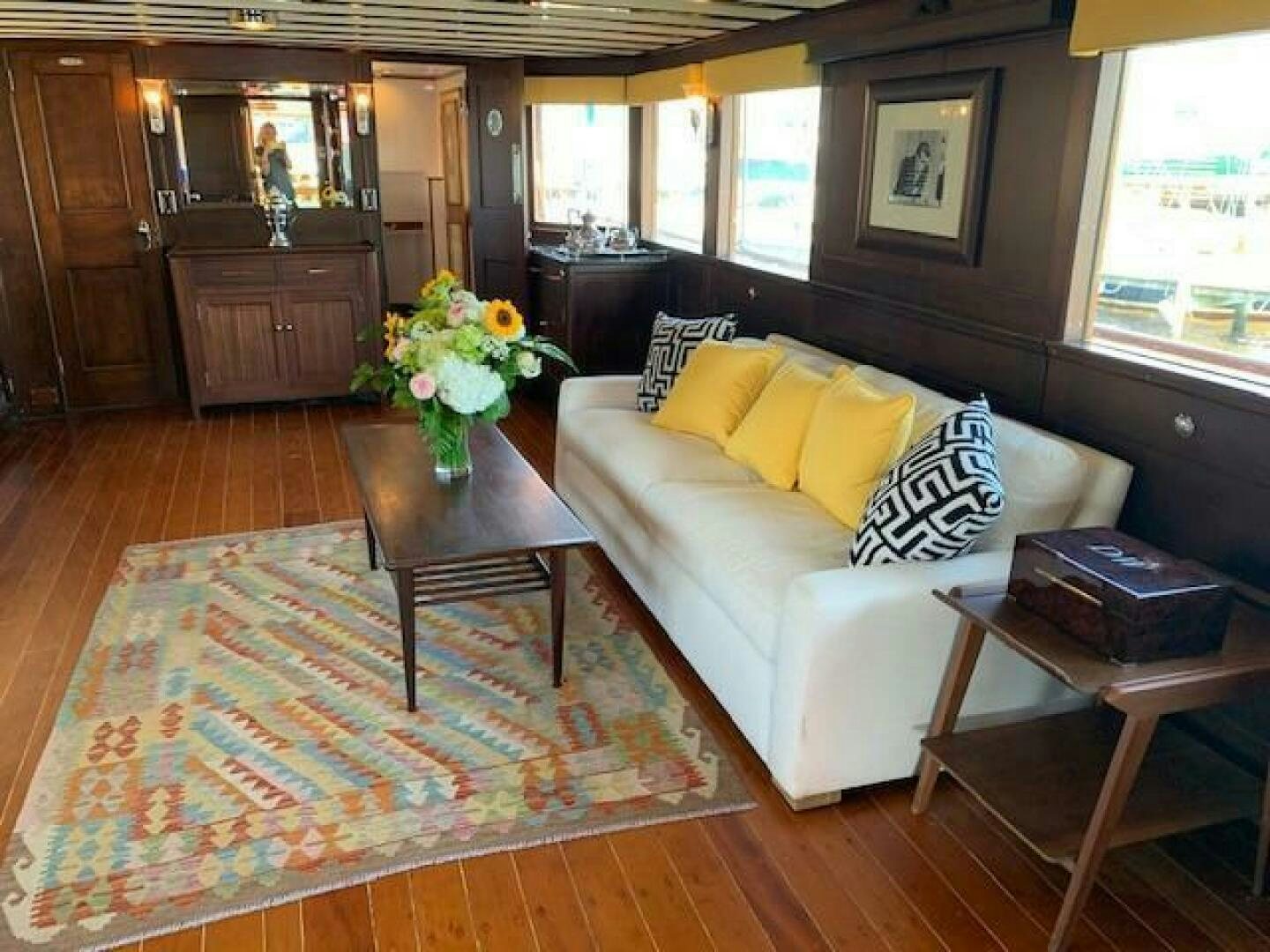 a living room with a couch and coffee table aboard TIMELESS Yacht for Sale