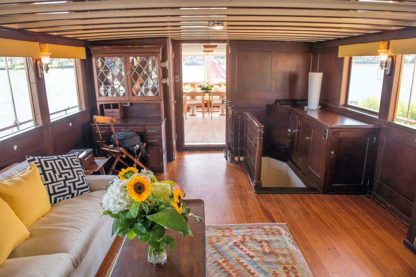 a living room with a wood floor aboard TIMELESS Yacht for Sale