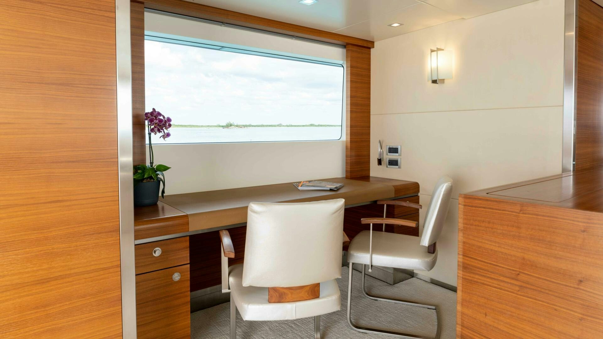 a room with a desk and chairs aboard SEA AXIS Yacht for Sale