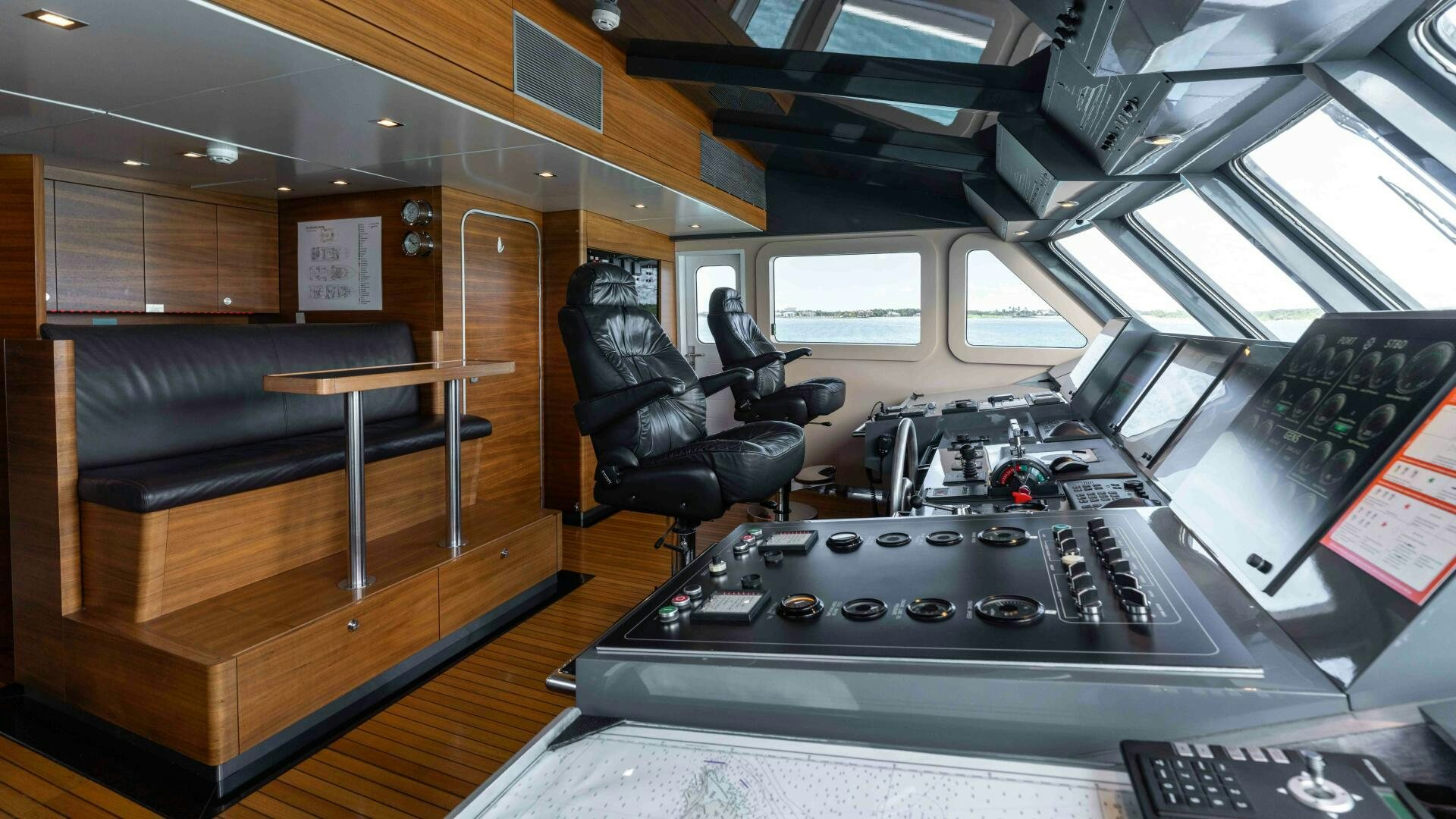 a room with a table and chairs aboard SEA AXIS Yacht for Sale