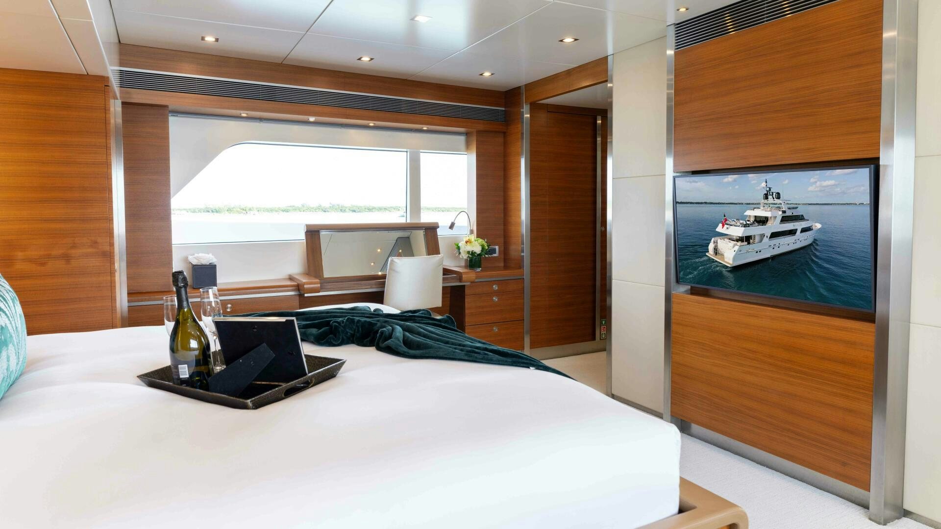 a room with a bed and a laptop on a table aboard SEA AXIS Yacht for Sale