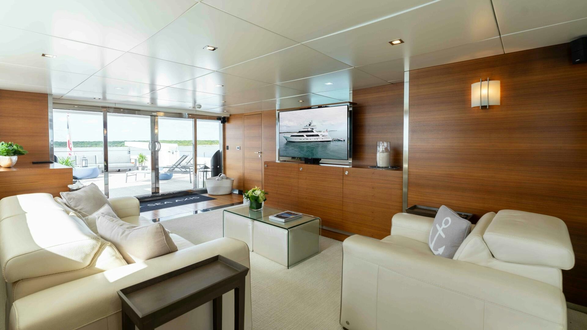 a room with a couch and a tv aboard SEA AXIS Yacht for Sale