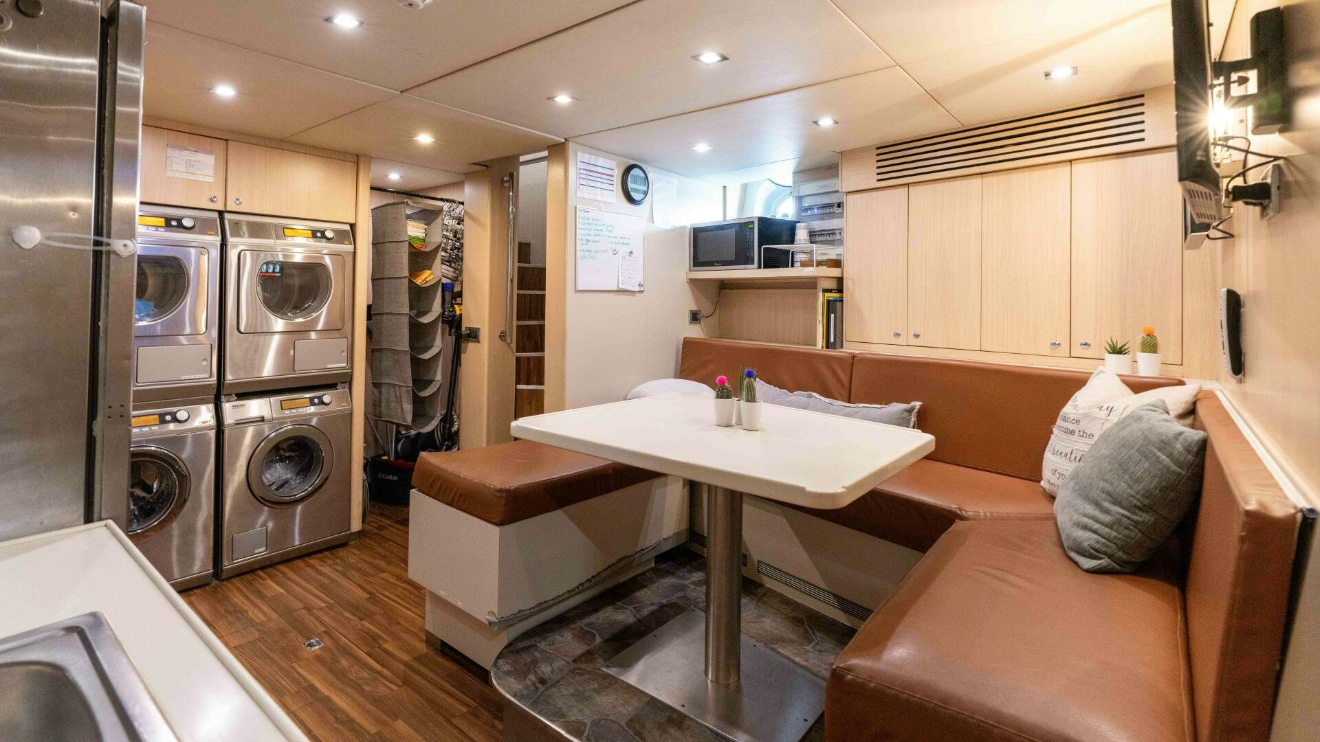 a room with a couch and a table aboard SEA AXIS Yacht for Sale
