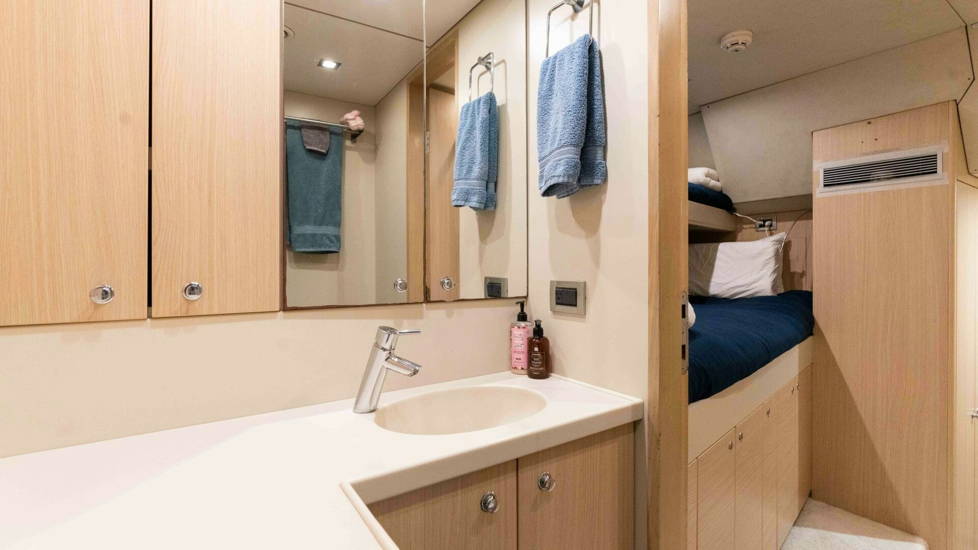 a bathroom with a sink and a mirror aboard SEA AXIS Yacht for Sale