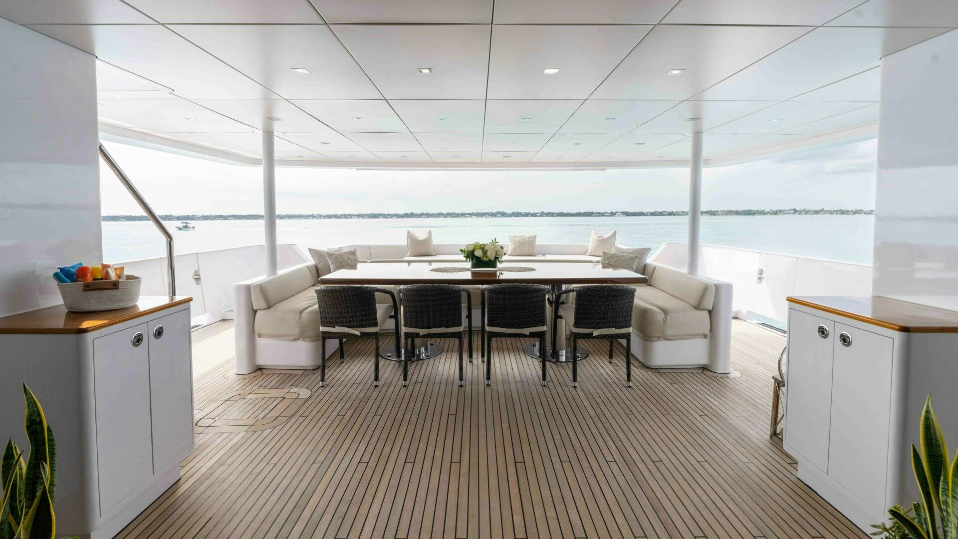 a room with a table chairs and a large window aboard SEA AXIS Yacht for Sale