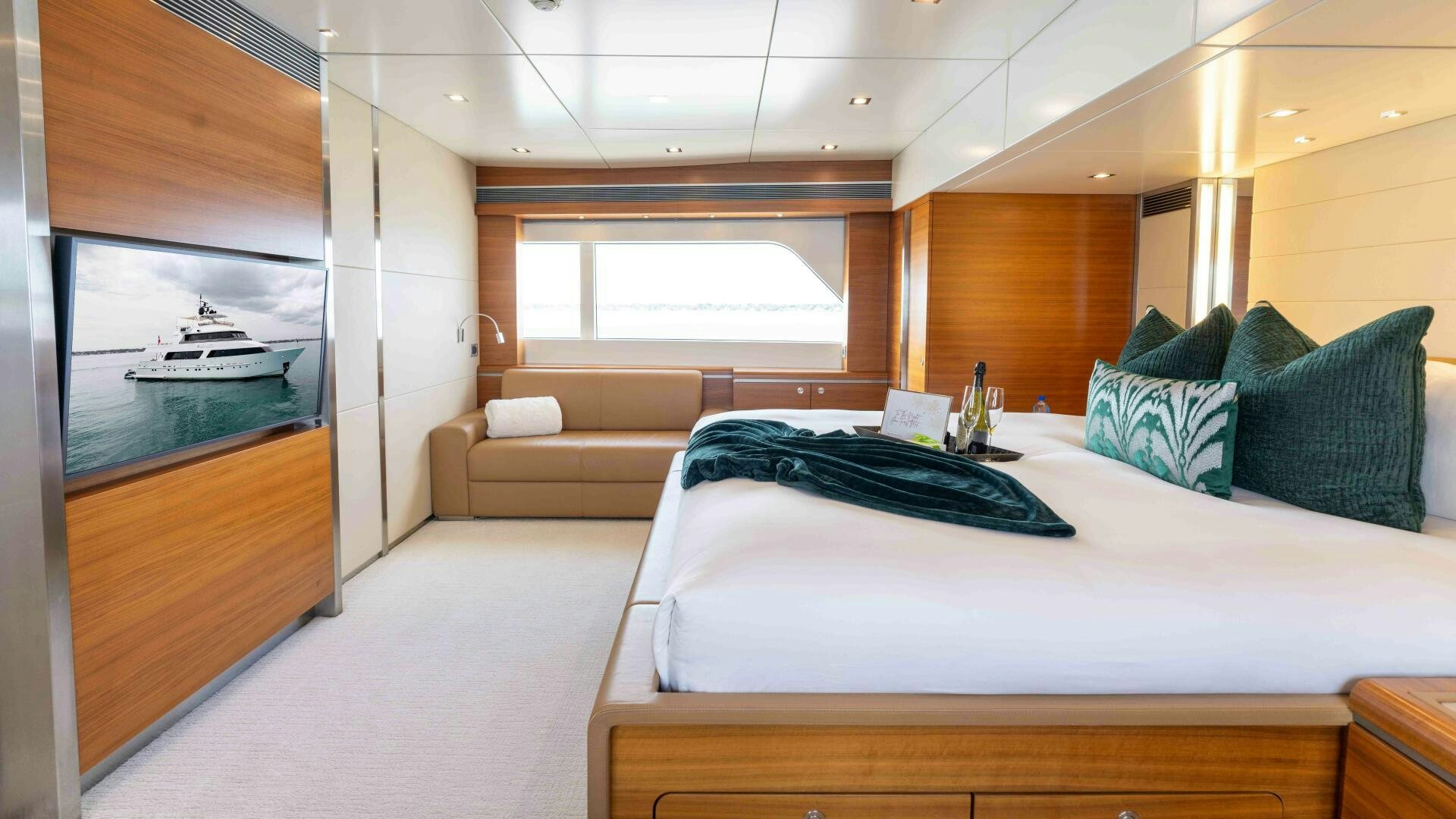 a room with a bed and a couch aboard SEA AXIS Yacht for Sale