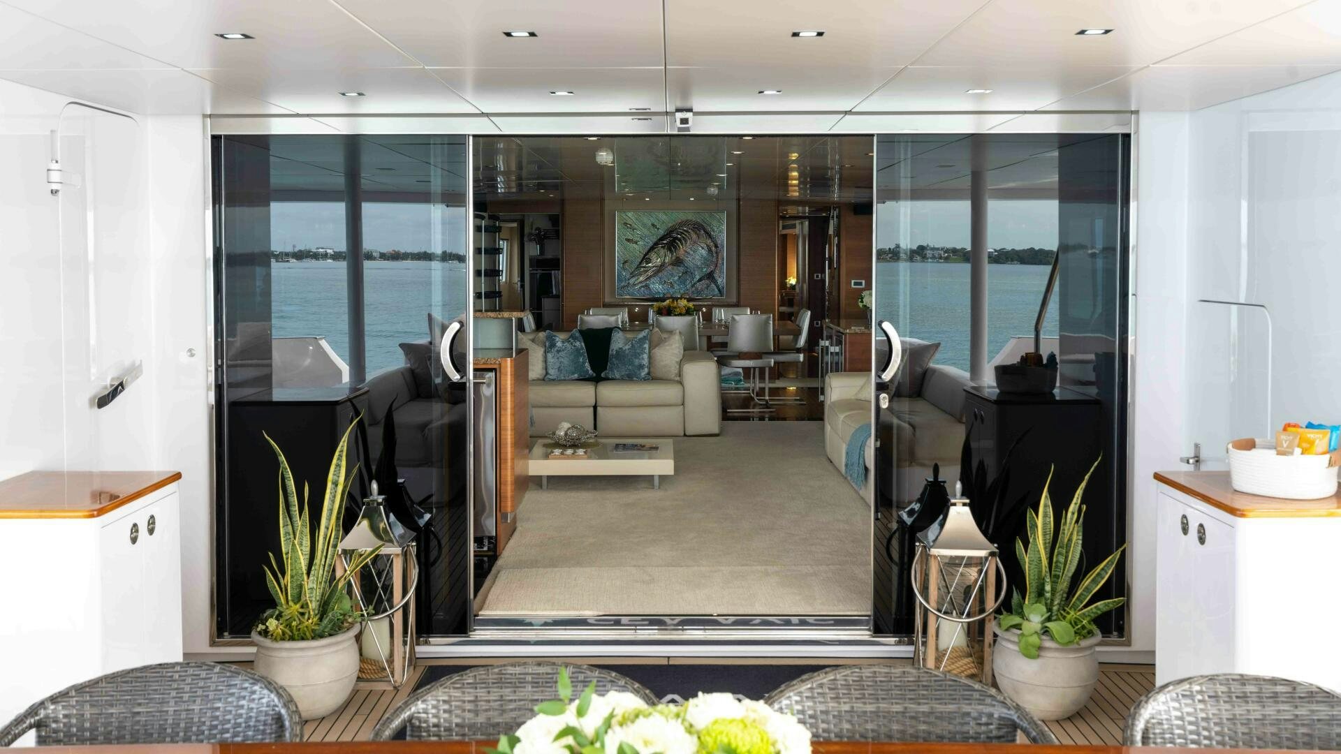 a living room with a glass door aboard SEA AXIS Yacht for Sale