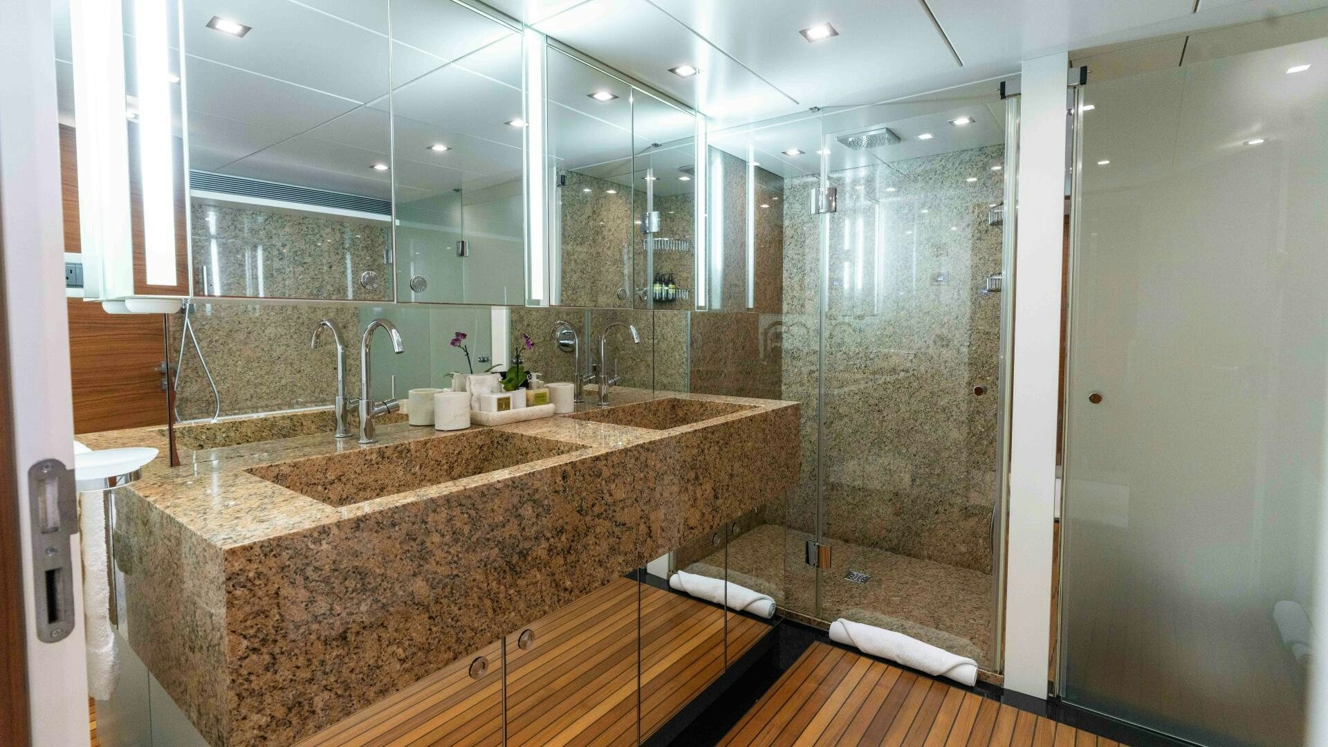 a bathroom with a countertop sink and a shower aboard SEA AXIS Yacht for Sale