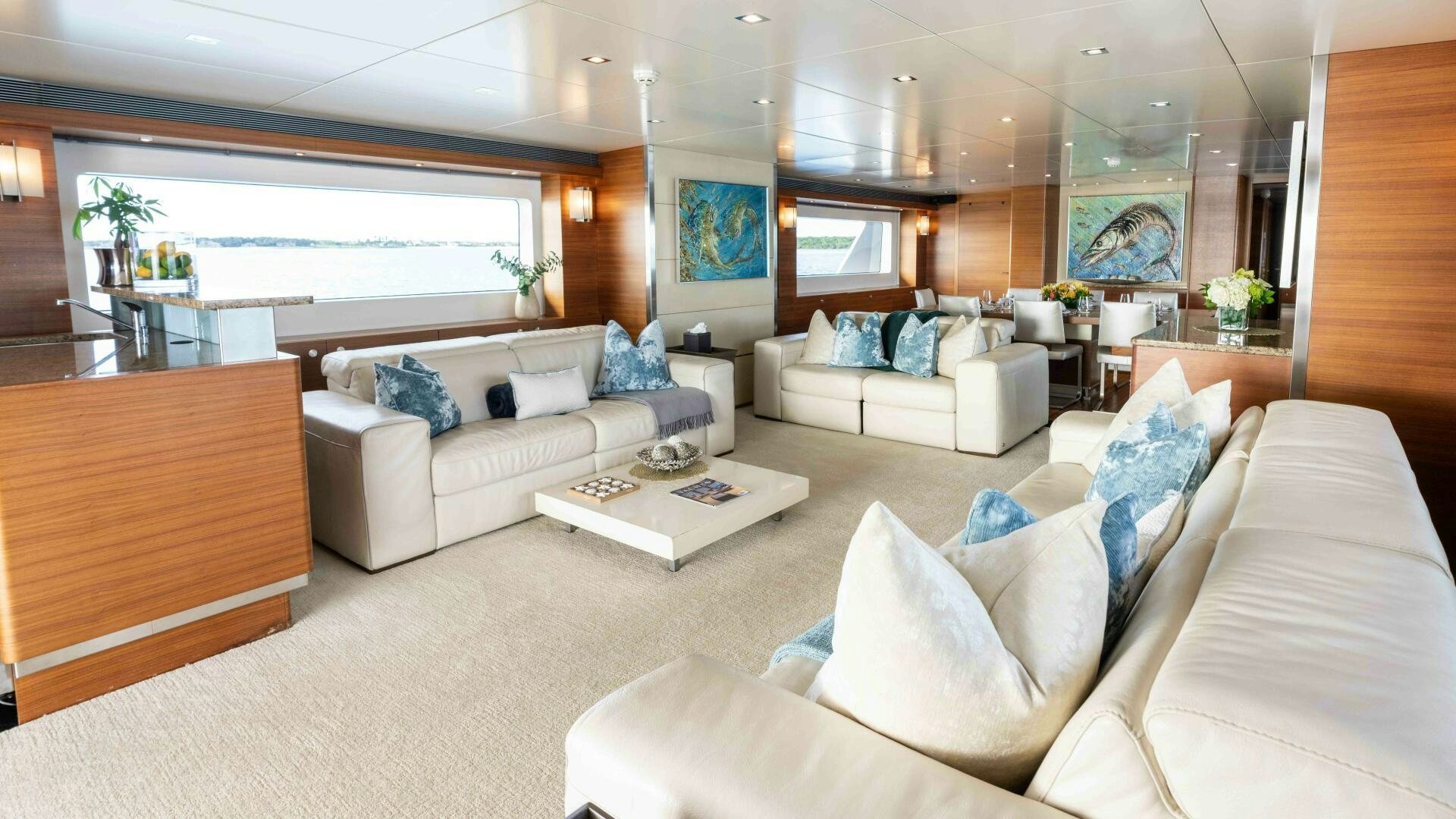 a living room with white couches aboard SEA AXIS Yacht for Sale