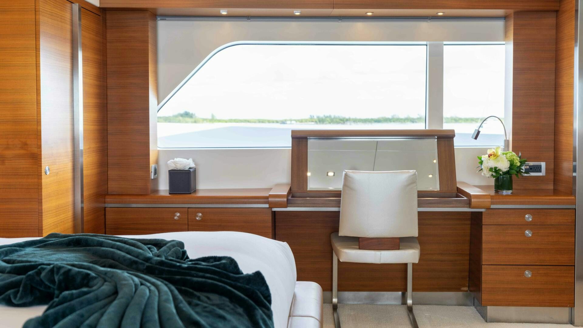 a room with a bed and a chair aboard SEA AXIS Yacht for Sale