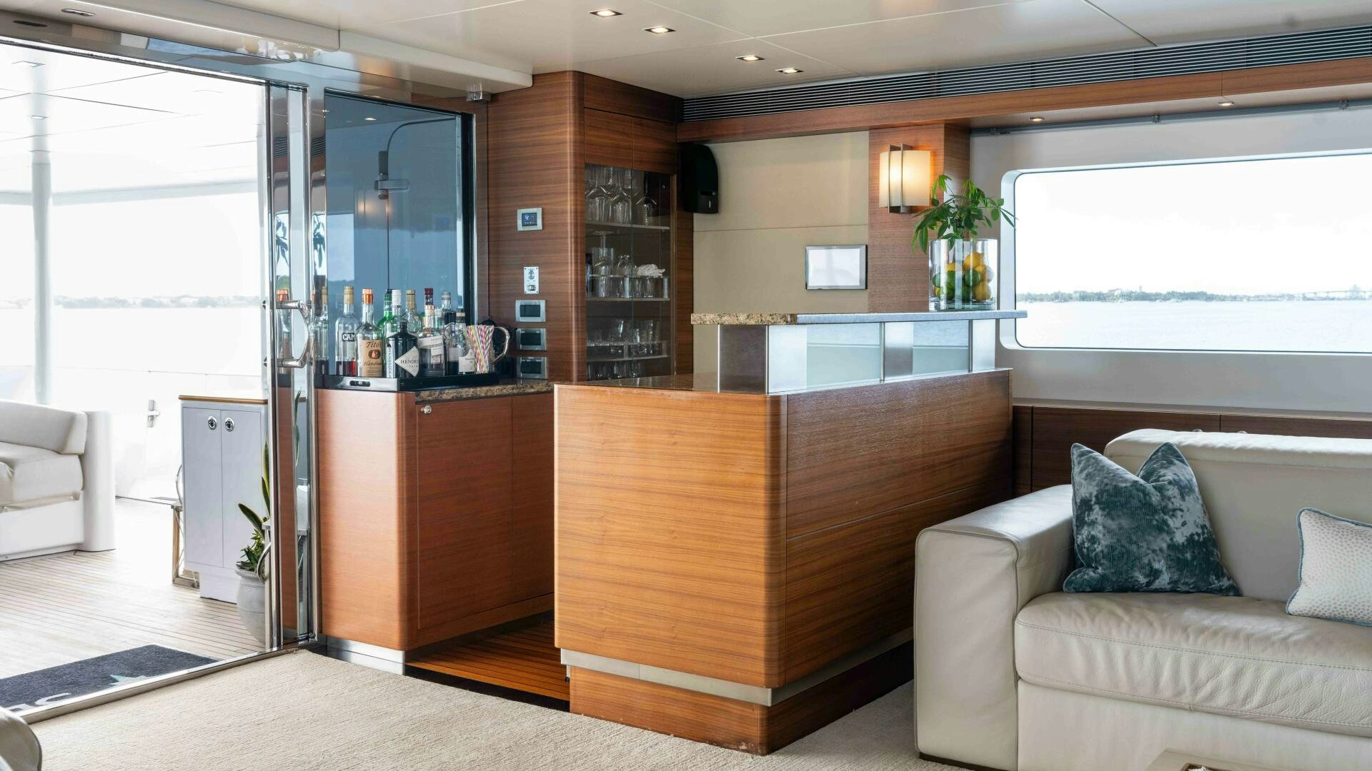 a living room with a couch and a kitchen aboard SEA AXIS Yacht for Sale