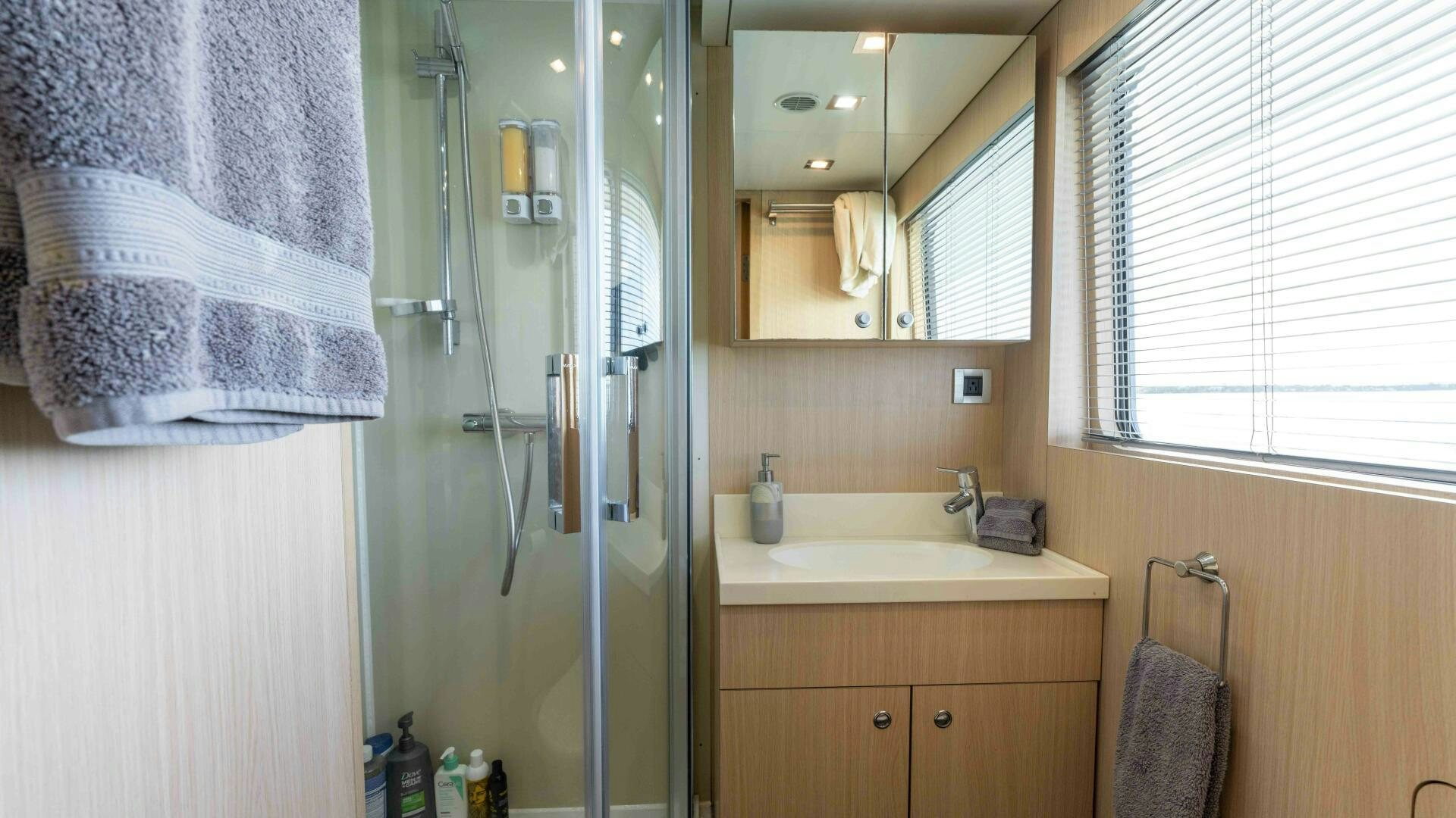 a bathroom with a shower unit and sink aboard SEA AXIS Yacht for Sale