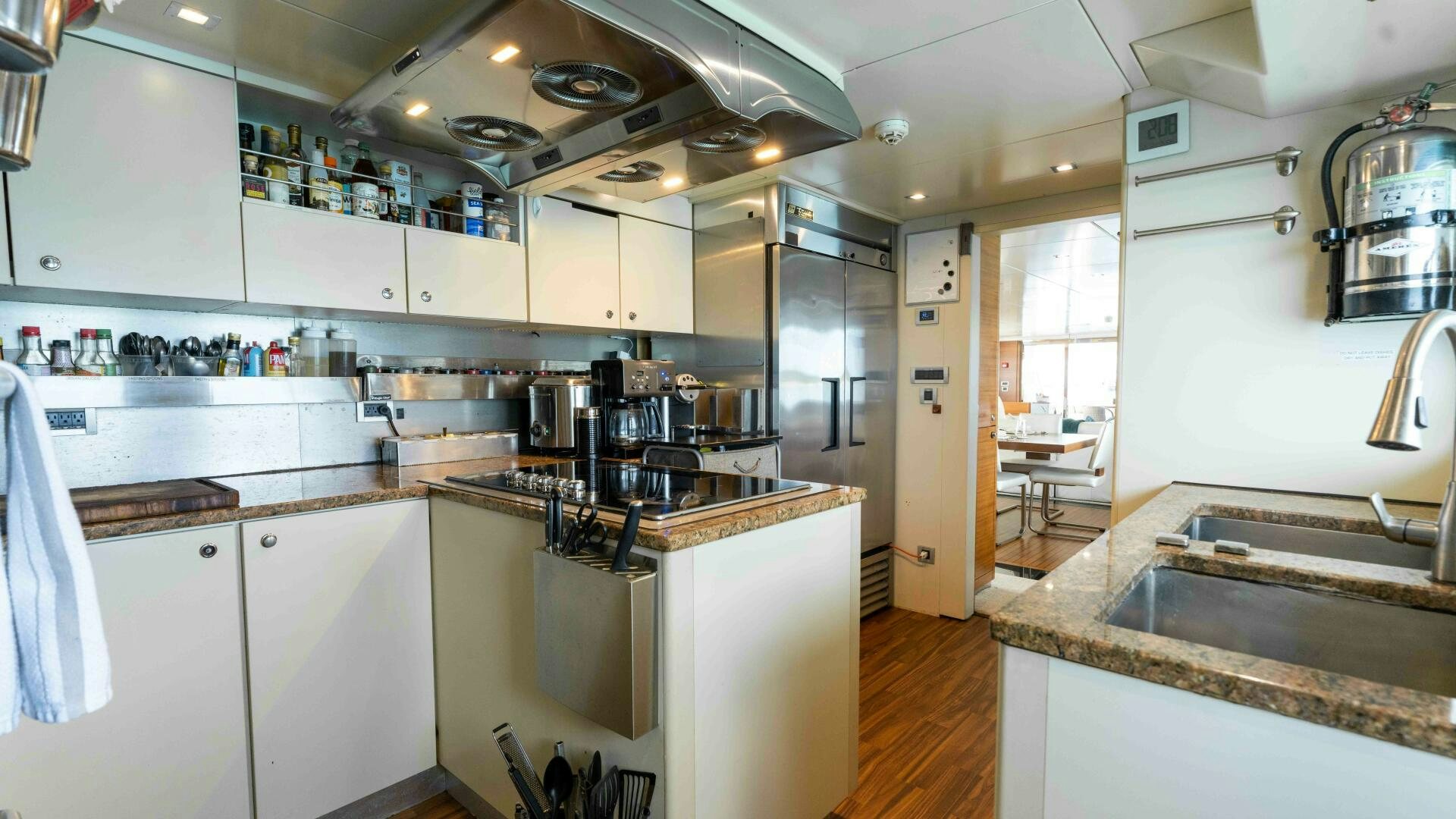 a kitchen with white cabinets aboard SEA AXIS Yacht for Sale