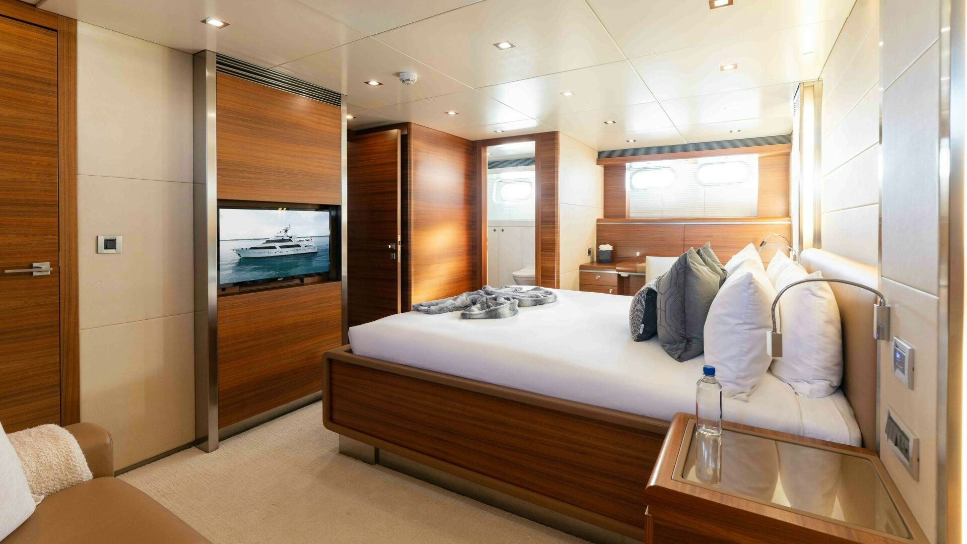 a room with a bed and a table aboard SEA AXIS Yacht for Sale