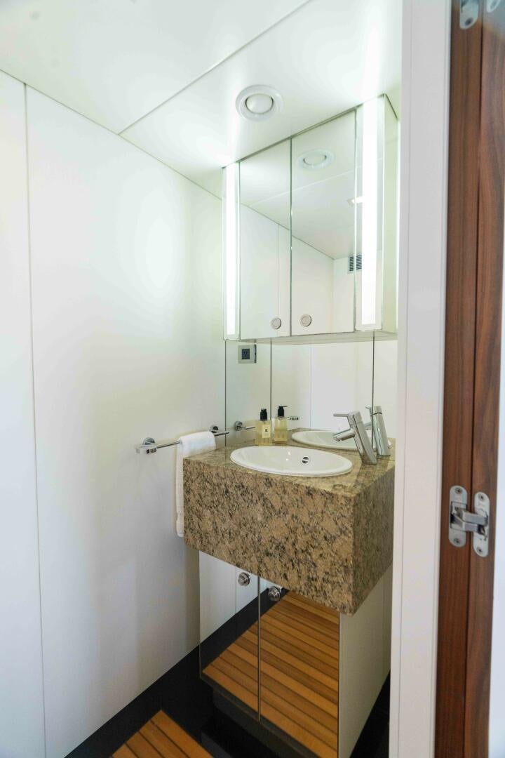 a bathroom with a sink and mirror aboard SEA AXIS Yacht for Sale