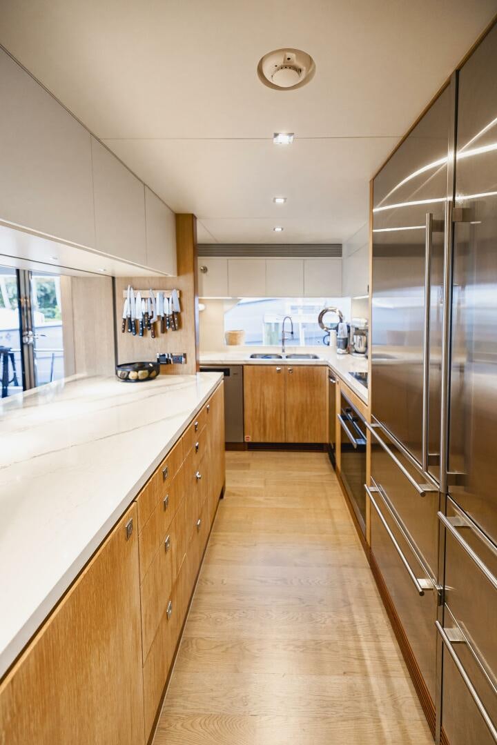 a kitchen with a stainless steel refrigerator aboard AQUA LIFE Yacht for Sale